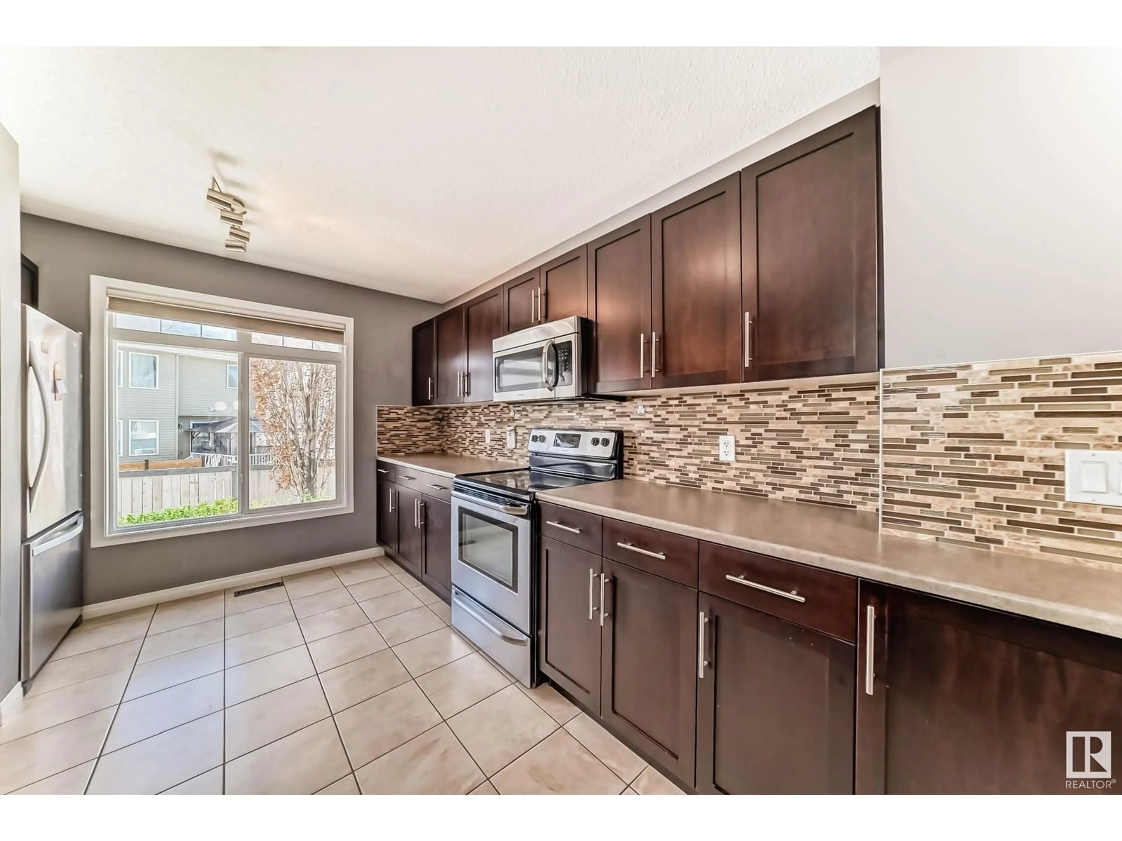 Open concept kitchen, ceramic/tile floor for #104 - 1804 70 ST, Edmonton Alberta T6X0H4
