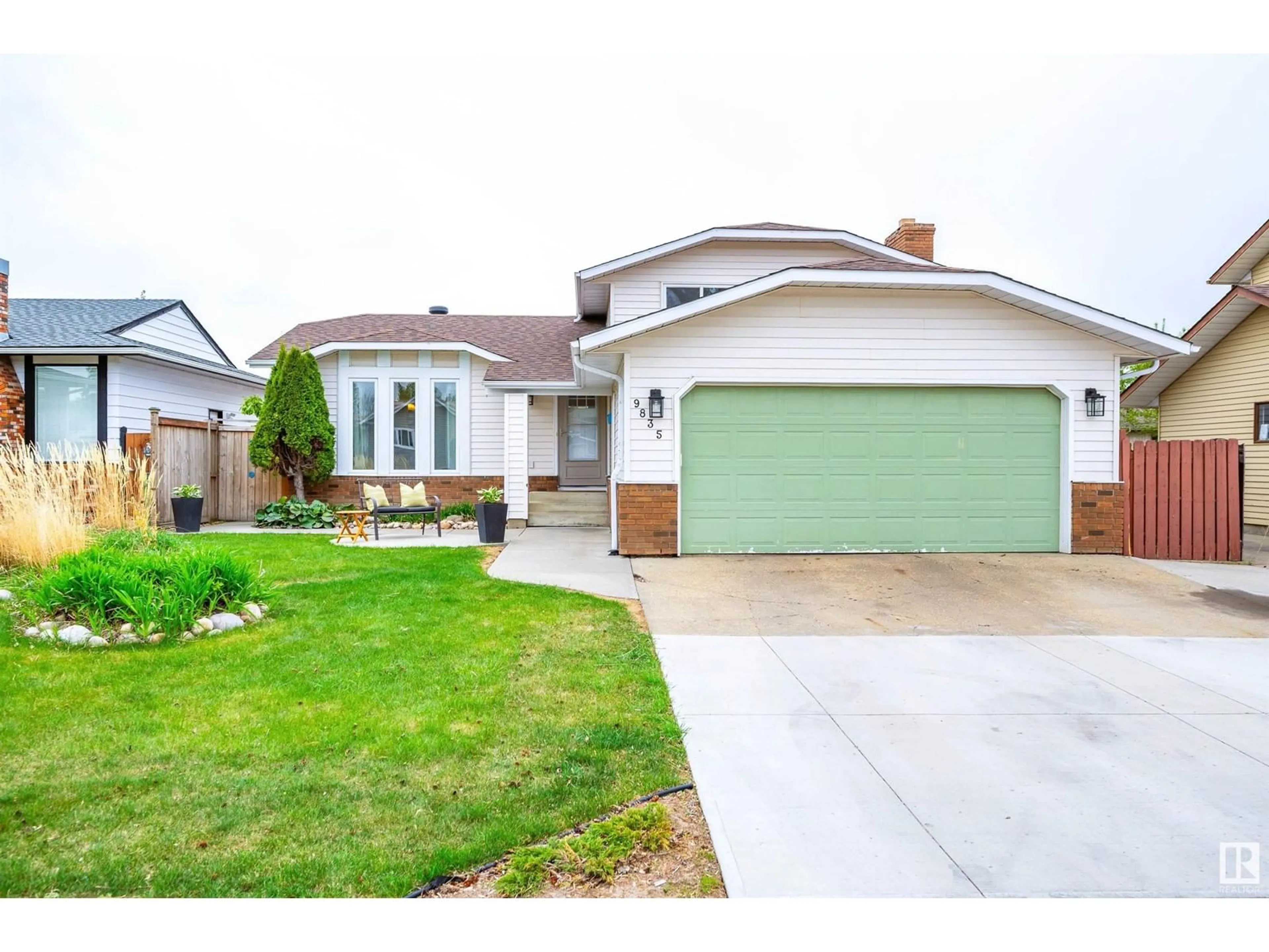 Home with vinyl exterior material, street for 9835 165 AV, Edmonton Alberta T5X4Z1