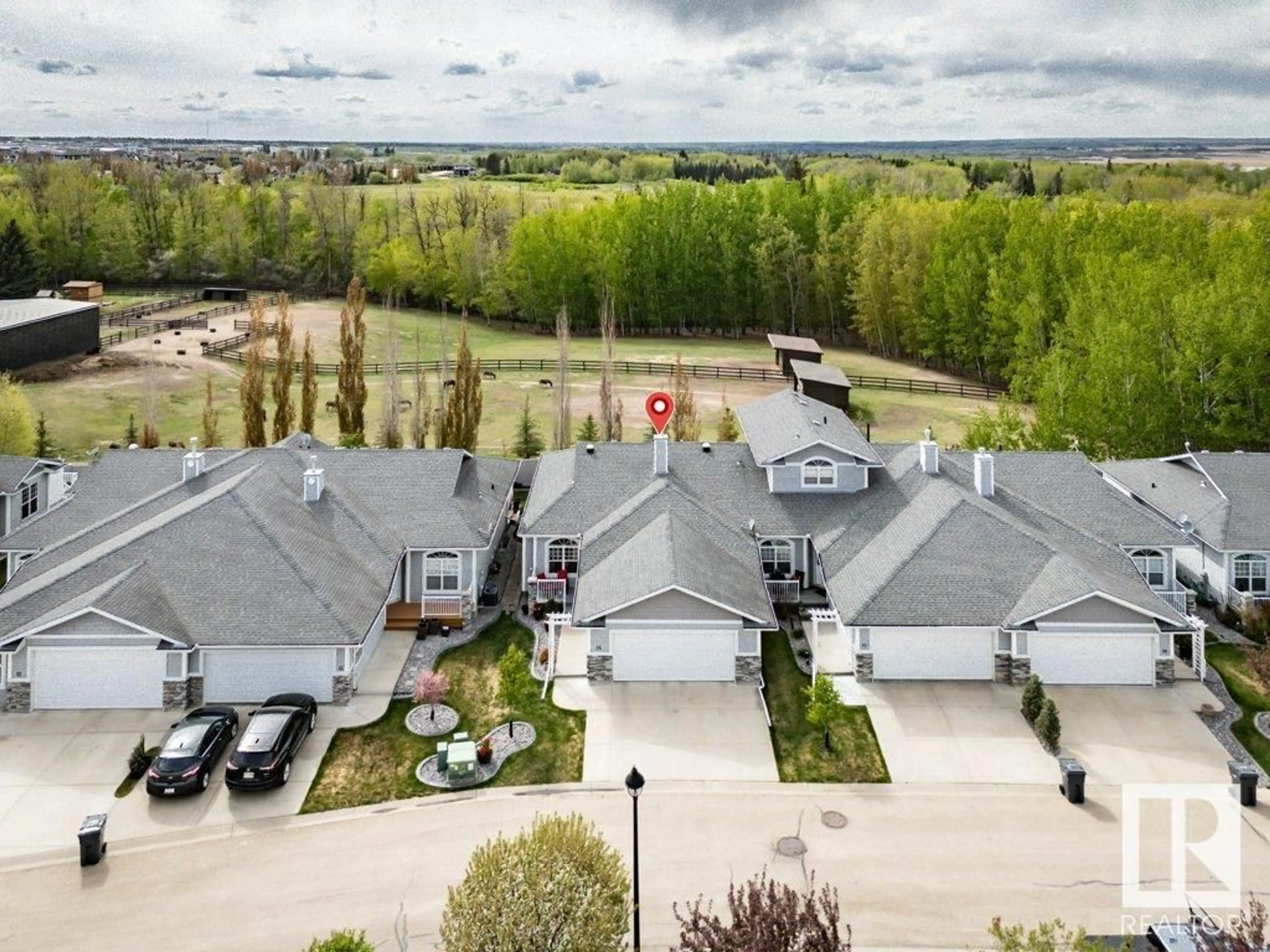 A pic from outside/outdoor area/front of a property/back of a property/a pic from drone, water/lake/river/ocean view for 14 - 26116 HGHWAY 16, Rural Parkland County Alberta T7Y1A1
