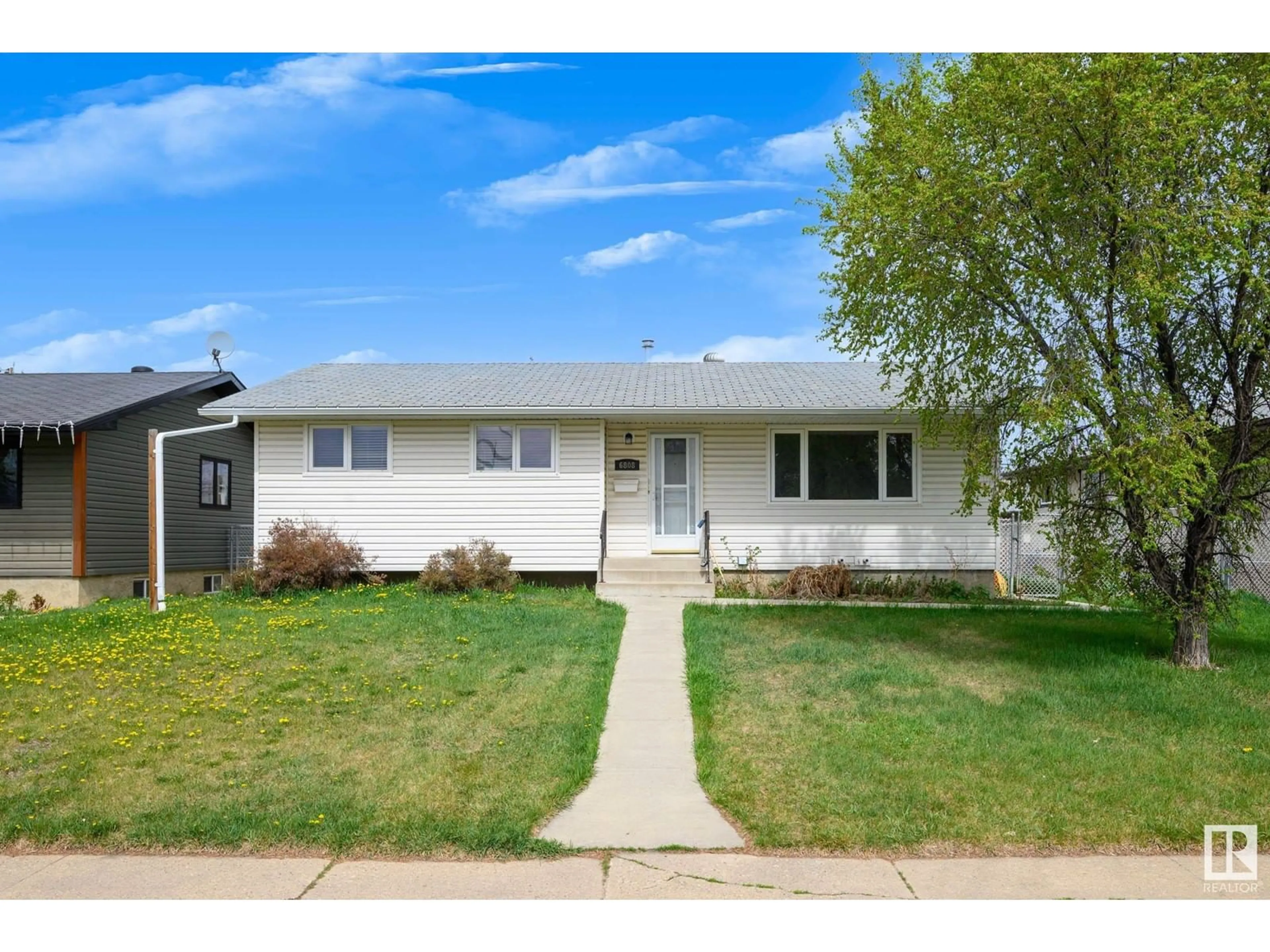 Home with vinyl exterior material, street for 6808 136 AV, Edmonton Alberta T5C2J9