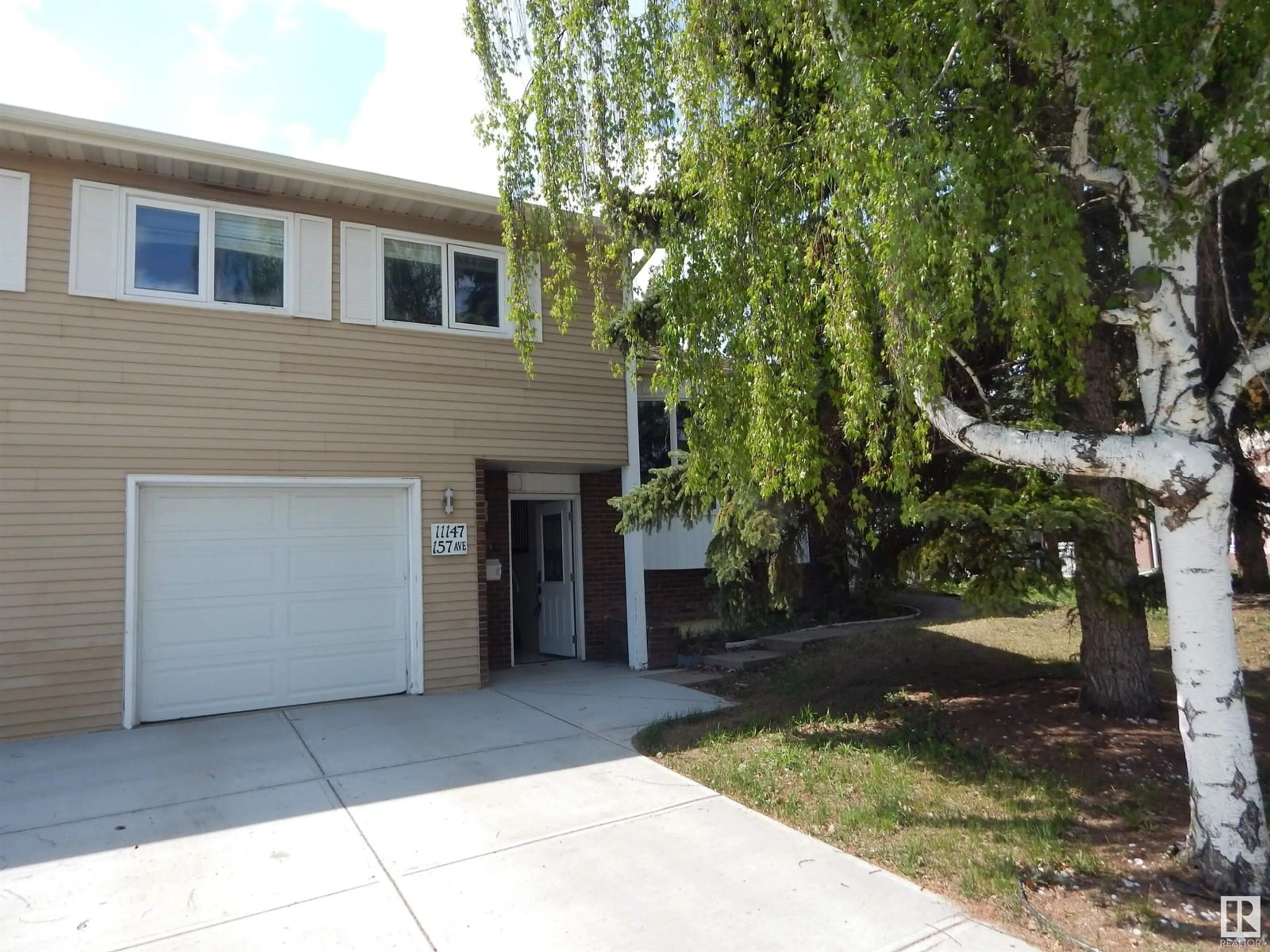 Home with vinyl exterior material, street for 11147 157 AV, Edmonton Alberta T5X4V1