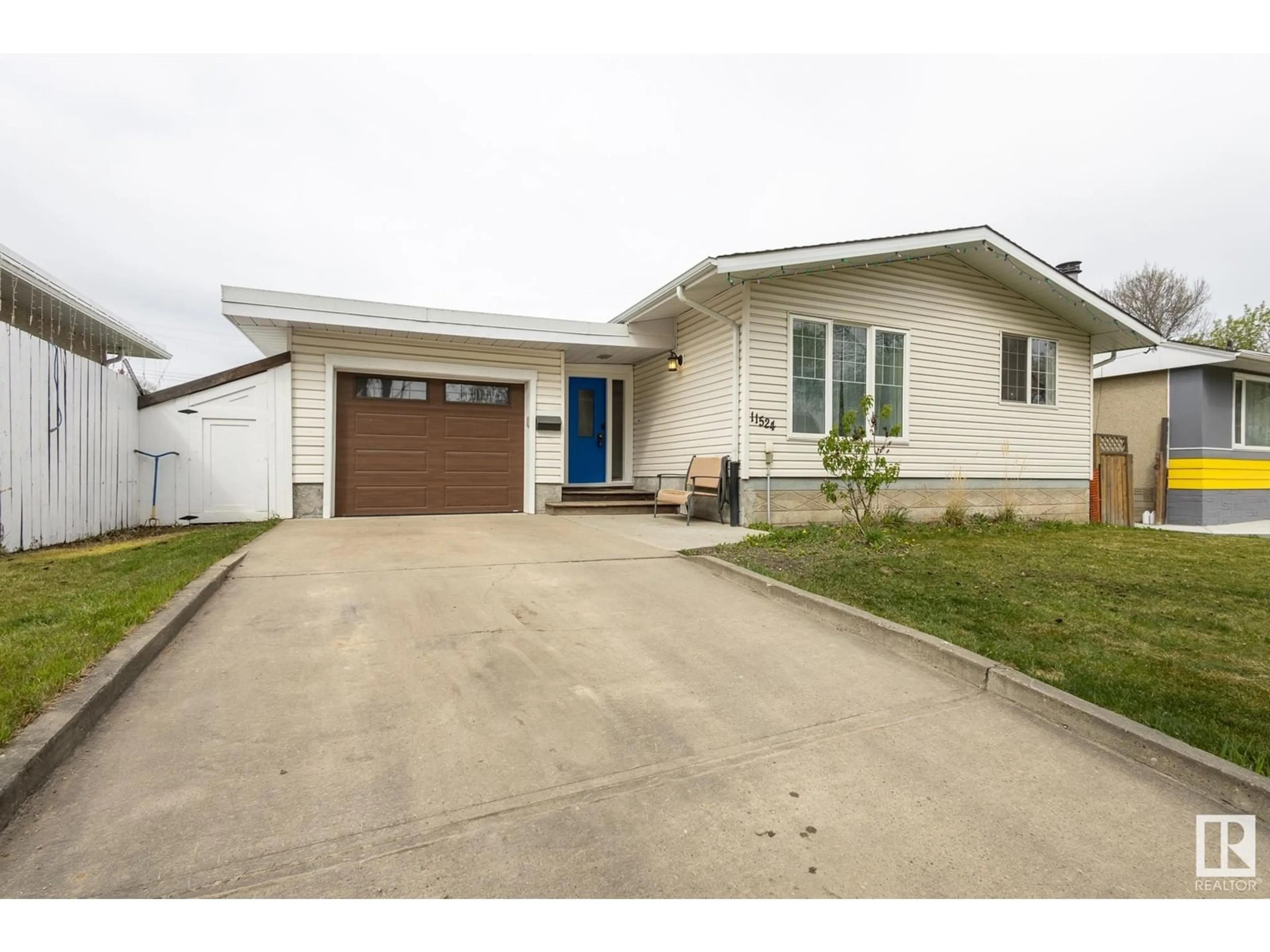 Home with vinyl exterior material, street for NW - 11524 135 ST, Edmonton Alberta T5M1K8