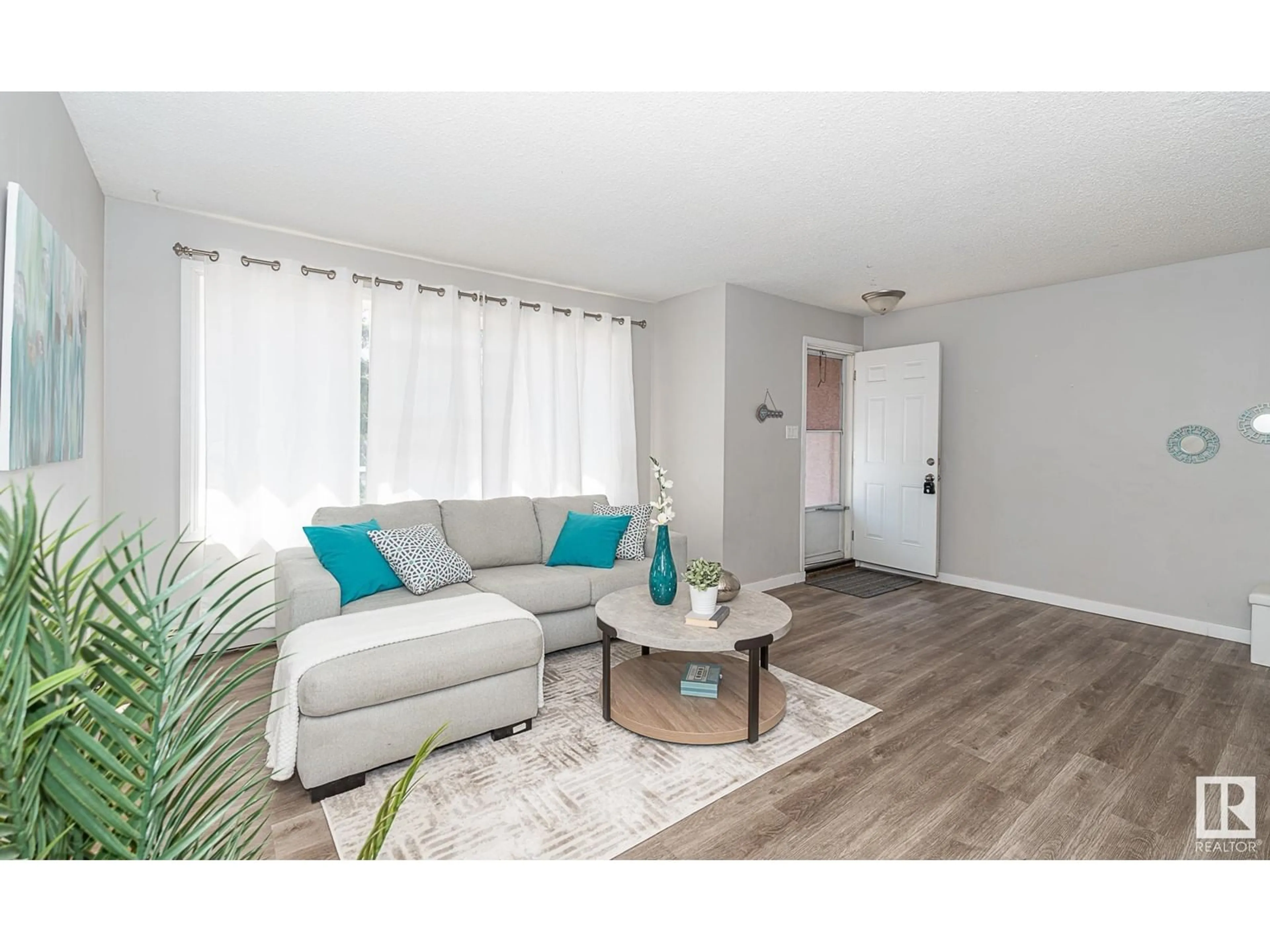 Living room with furniture, wood/laminate floor for #4 - 13570 38 ST, Edmonton Alberta T5A2W7