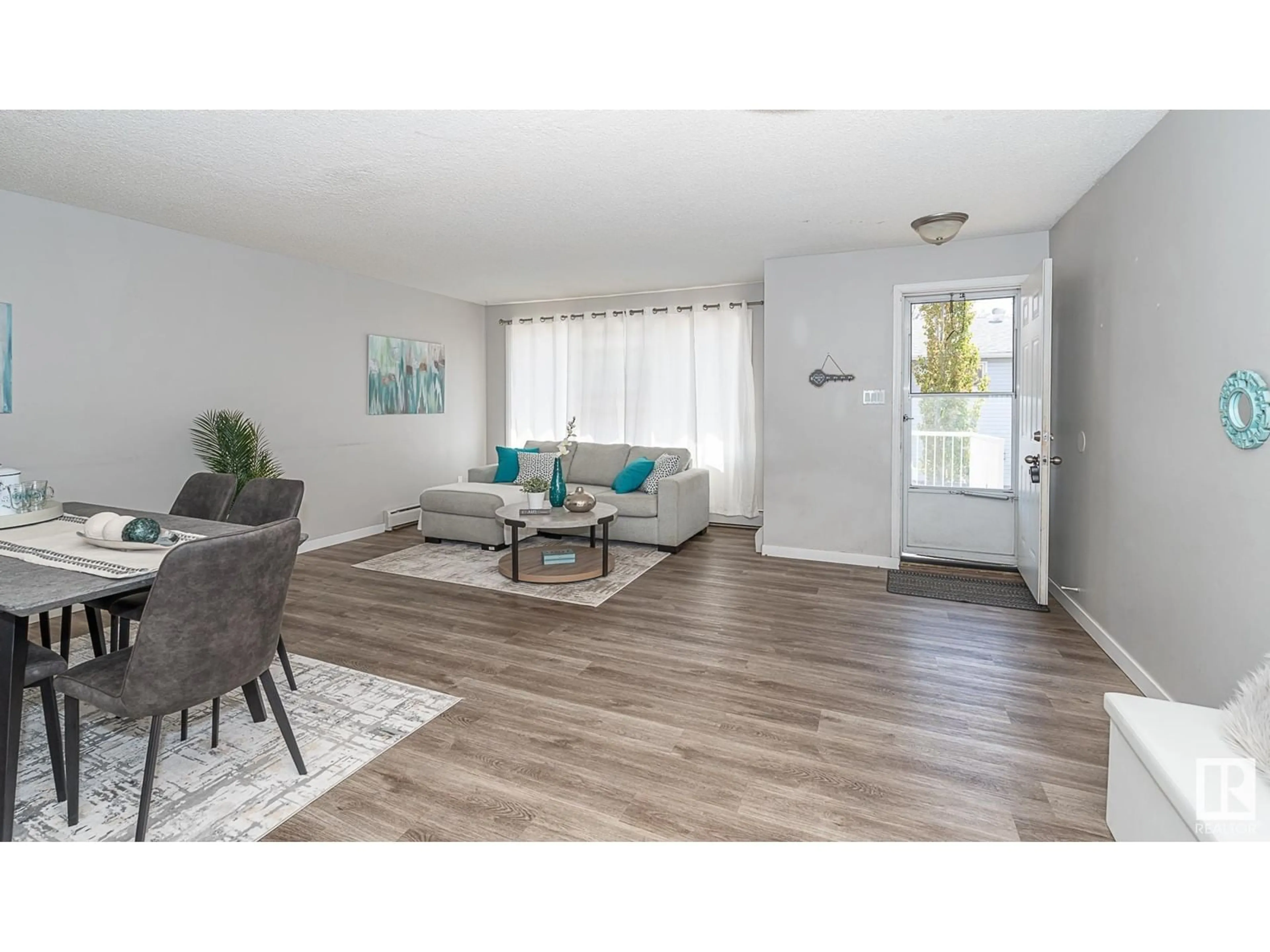 Living room with furniture, wood/laminate floor for #4 - 13570 38 ST, Edmonton Alberta T5A2W7
