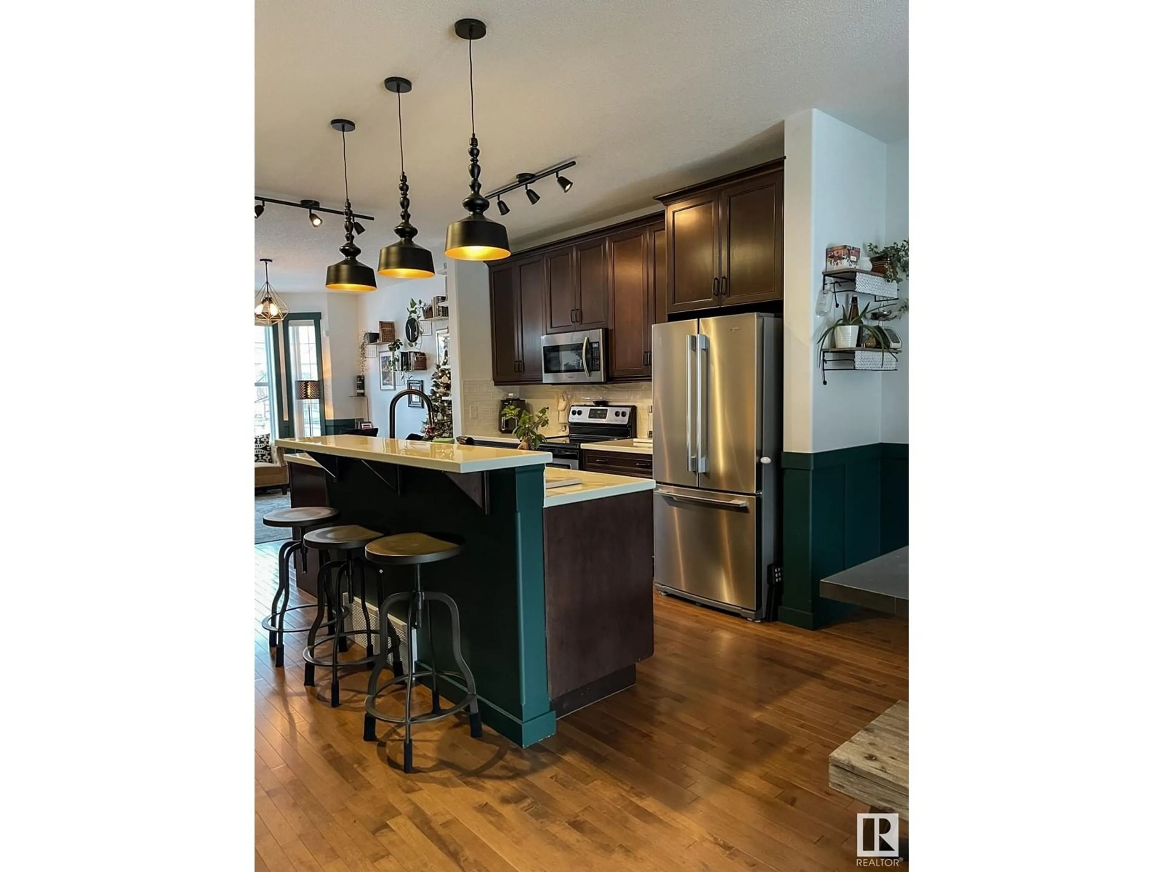 Open concept kitchen, wood/laminate floor for 1064 GAULT BV, Edmonton Alberta T5E6N7