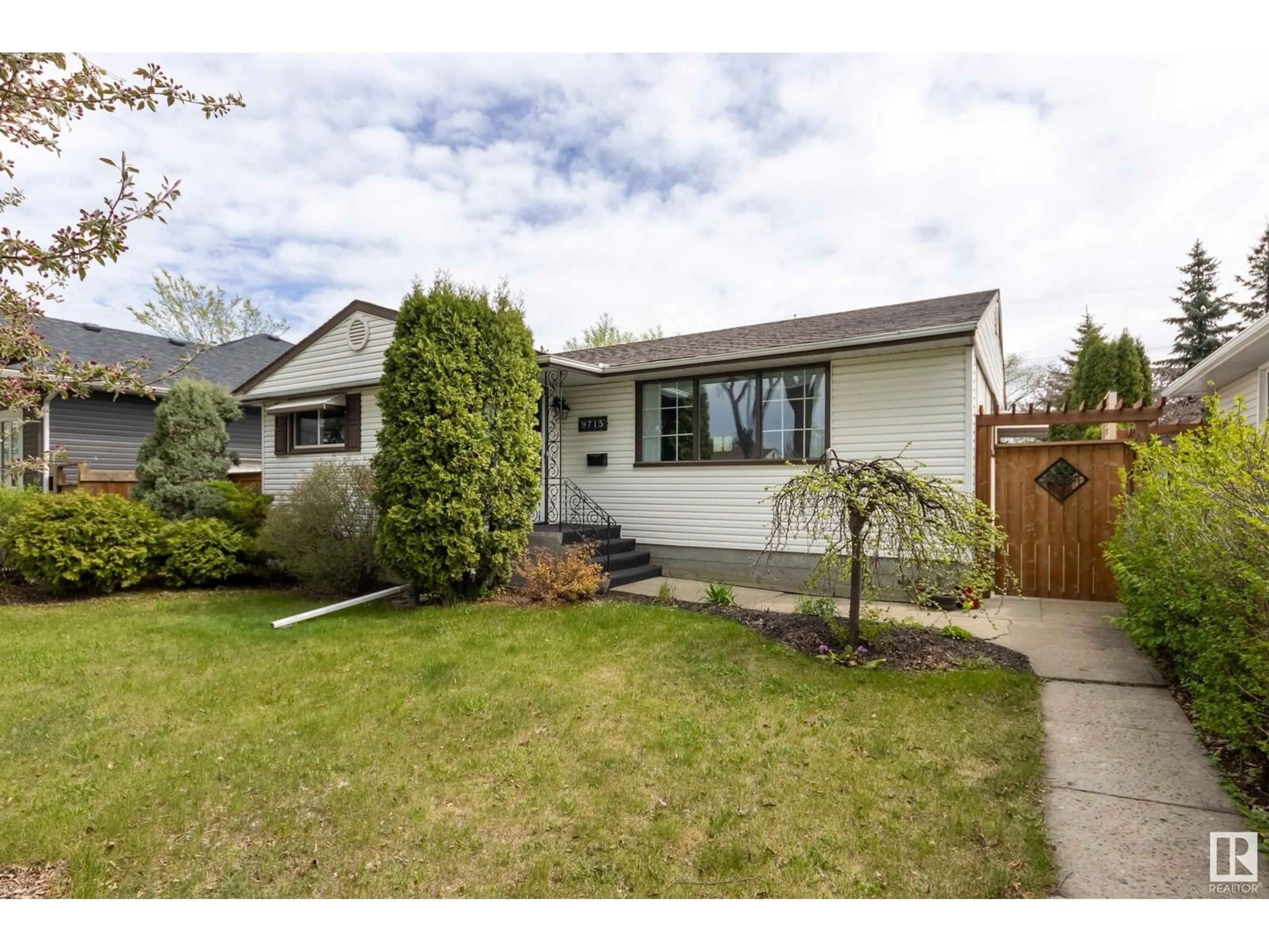 Home with vinyl exterior material, street for 9715 76 ST, Edmonton Alberta T6C2L1