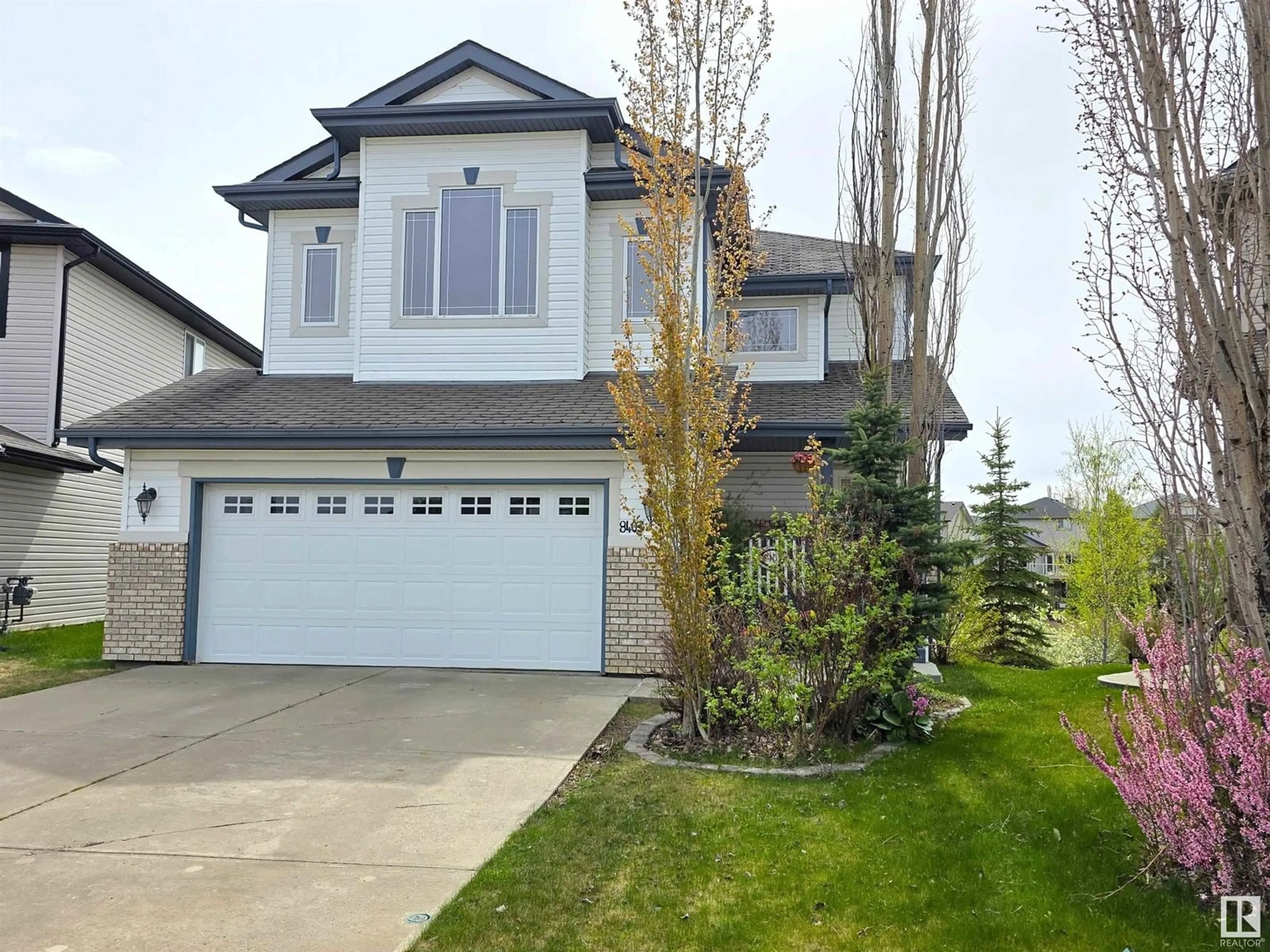 Home with vinyl exterior material, street for 8403 5 AV SW, Edmonton Alberta T6X1H9
