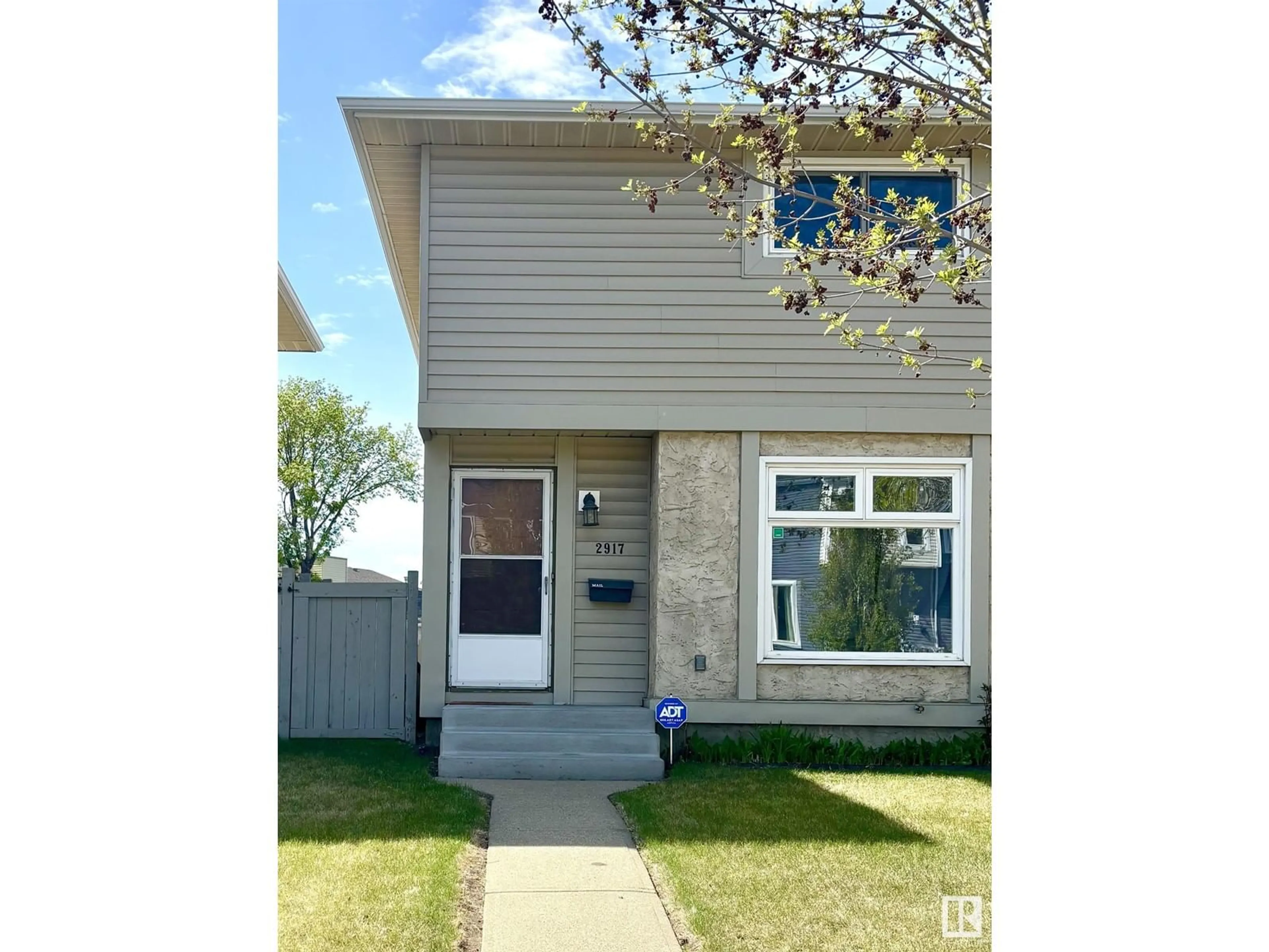 Home with vinyl exterior material, street for NW - 2917 151 AV, Edmonton Alberta T5Y2E3