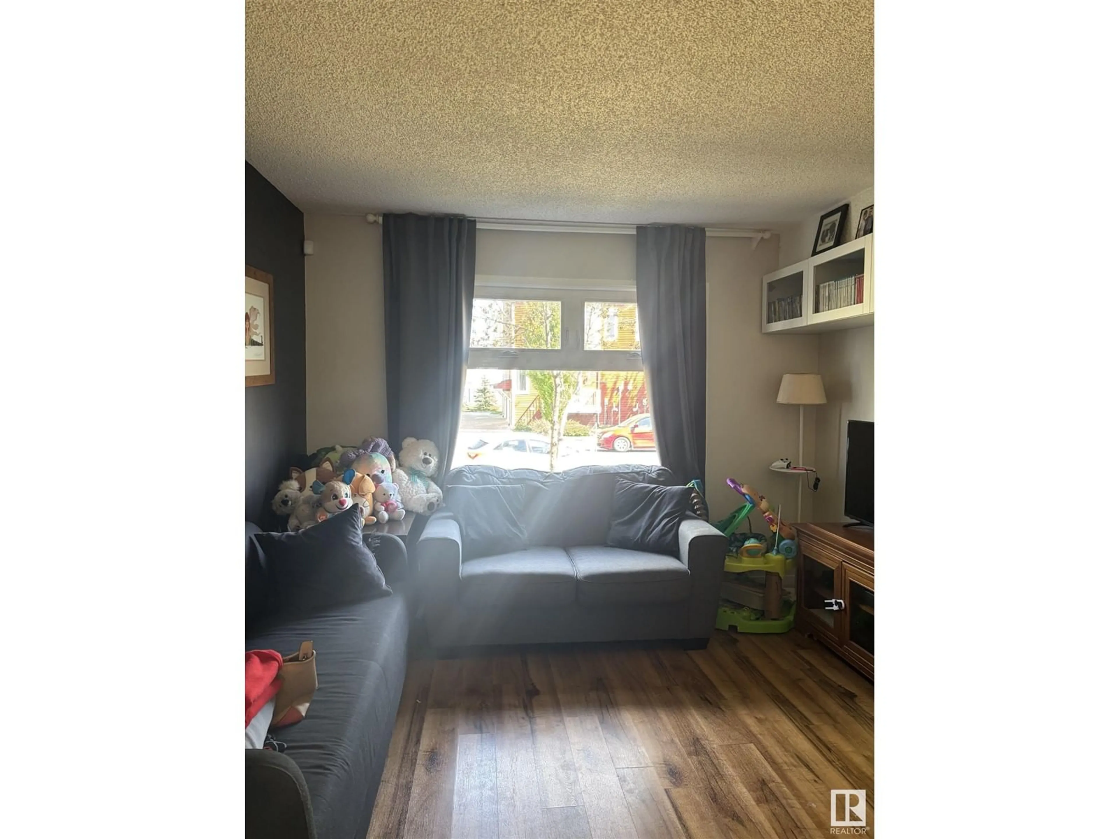 Living room with furniture, wood/laminate floor for NW - 2917 151 AV, Edmonton Alberta T5Y2E3