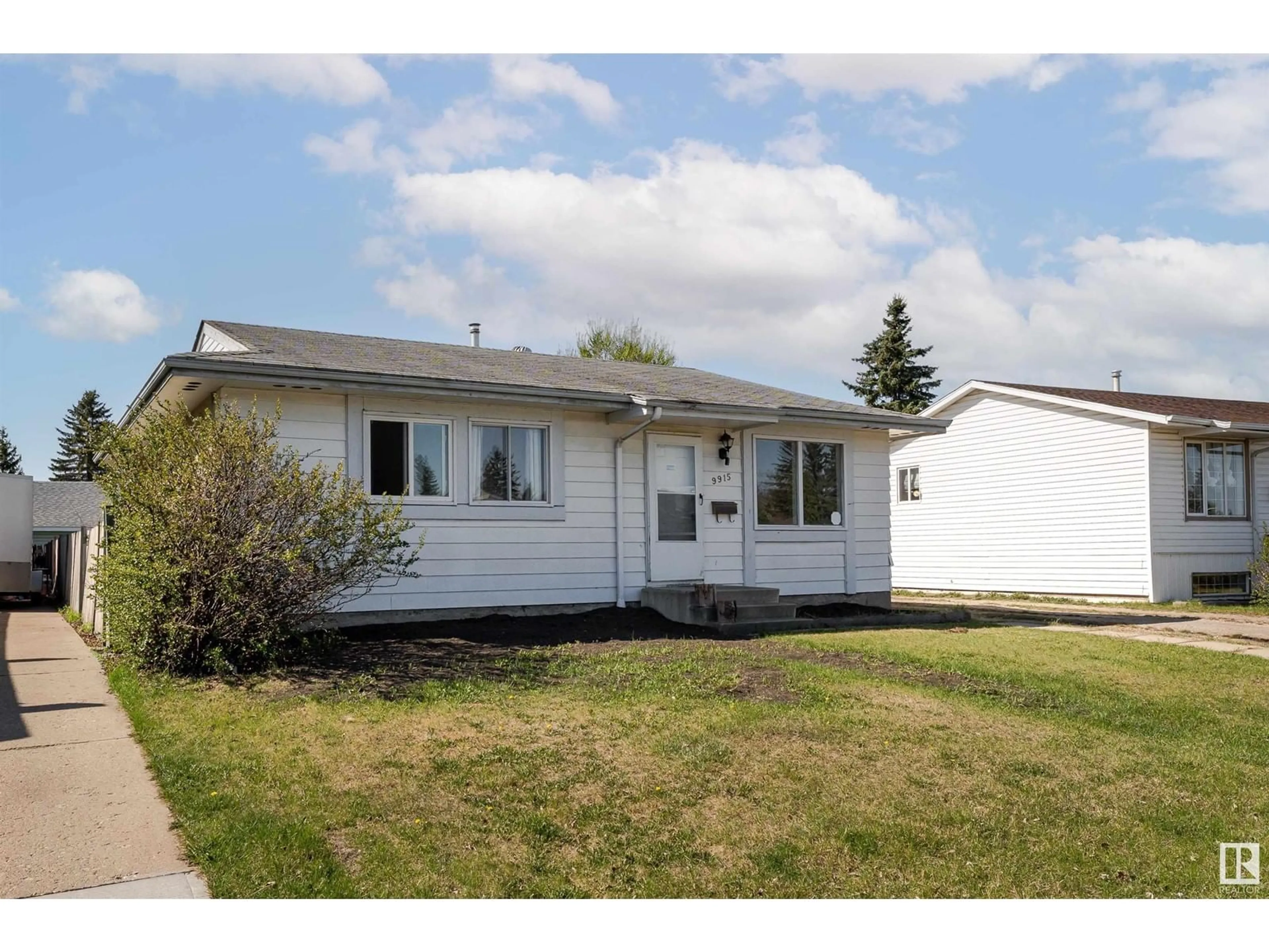 Home with vinyl exterior material, street for 9915 170 AV, Edmonton Alberta T5X3G3