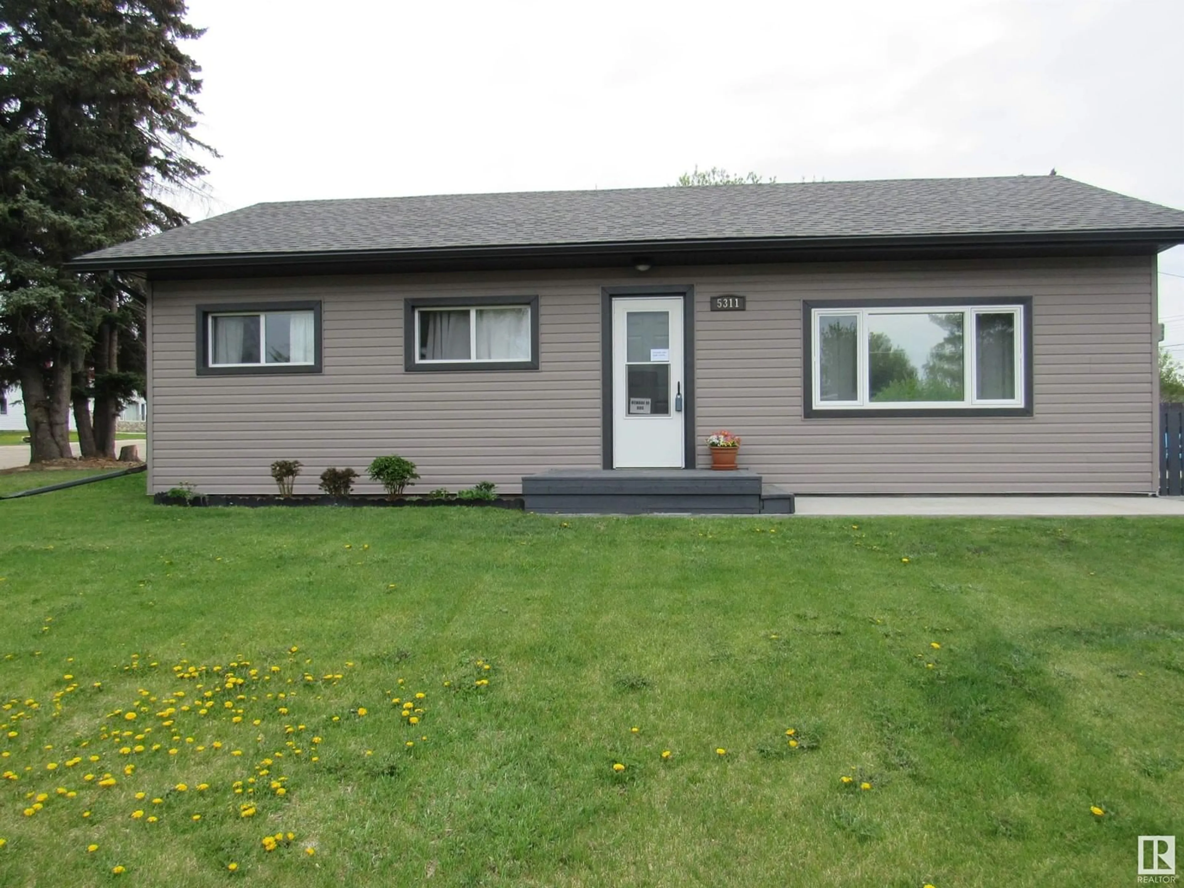 Home with vinyl exterior material, street for 5311 46 STREET, Barrhead Alberta T7N1P7