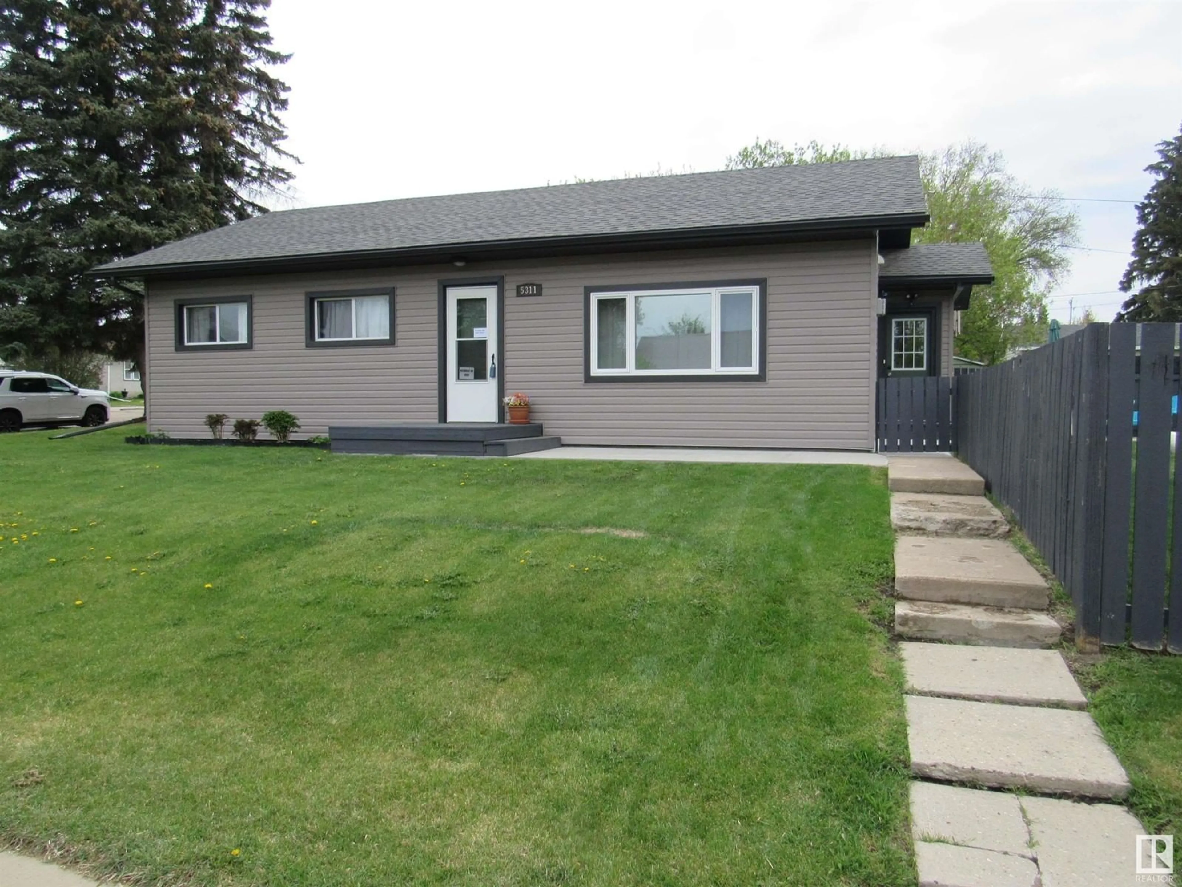 Home with vinyl exterior material, street for 5311 46 STREET, Barrhead Alberta T7N1P7
