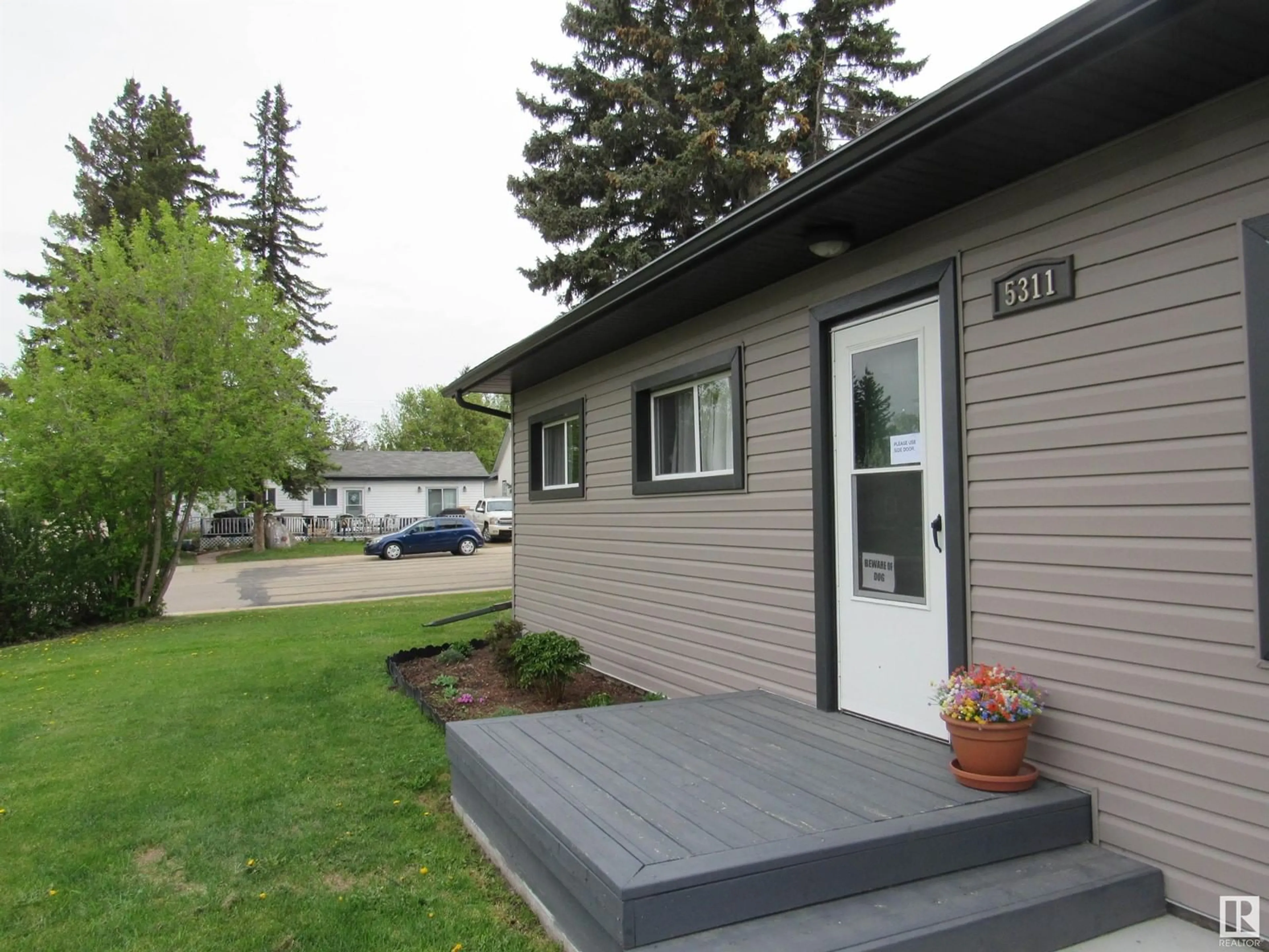 Home with vinyl exterior material, street for 5311 46 STREET, Barrhead Alberta T7N1P7