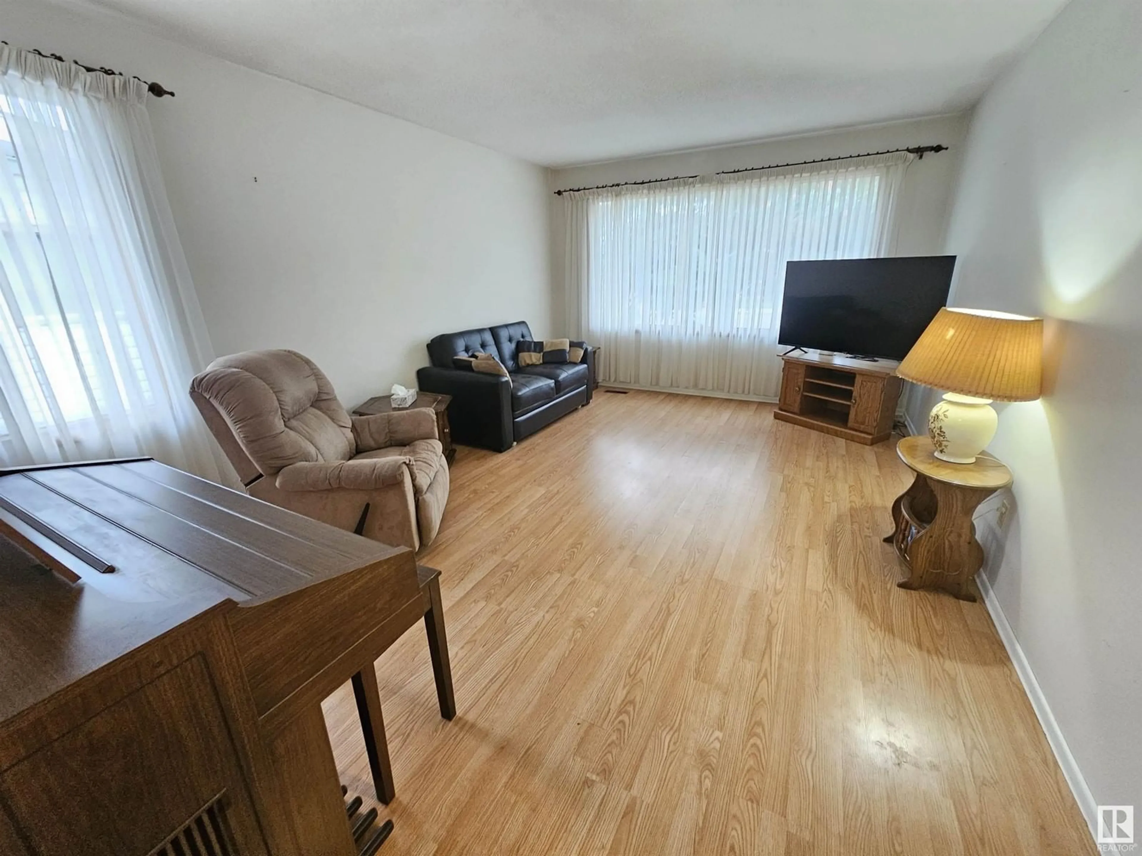 Living room with furniture, wood/laminate floor for 13807 74 ST, Edmonton Alberta T5C0X8