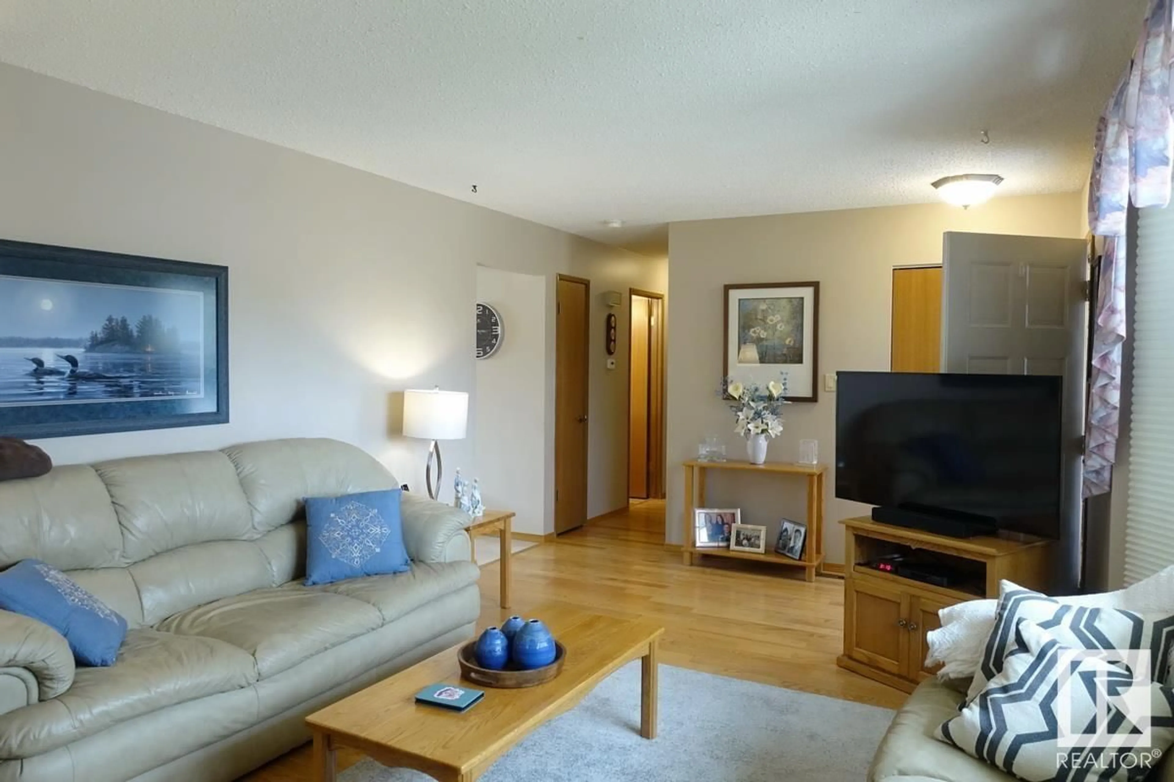 Living room with furniture, wood/laminate floor for 8217 99 AV, Fort Saskatchewan Alberta T8L3E4