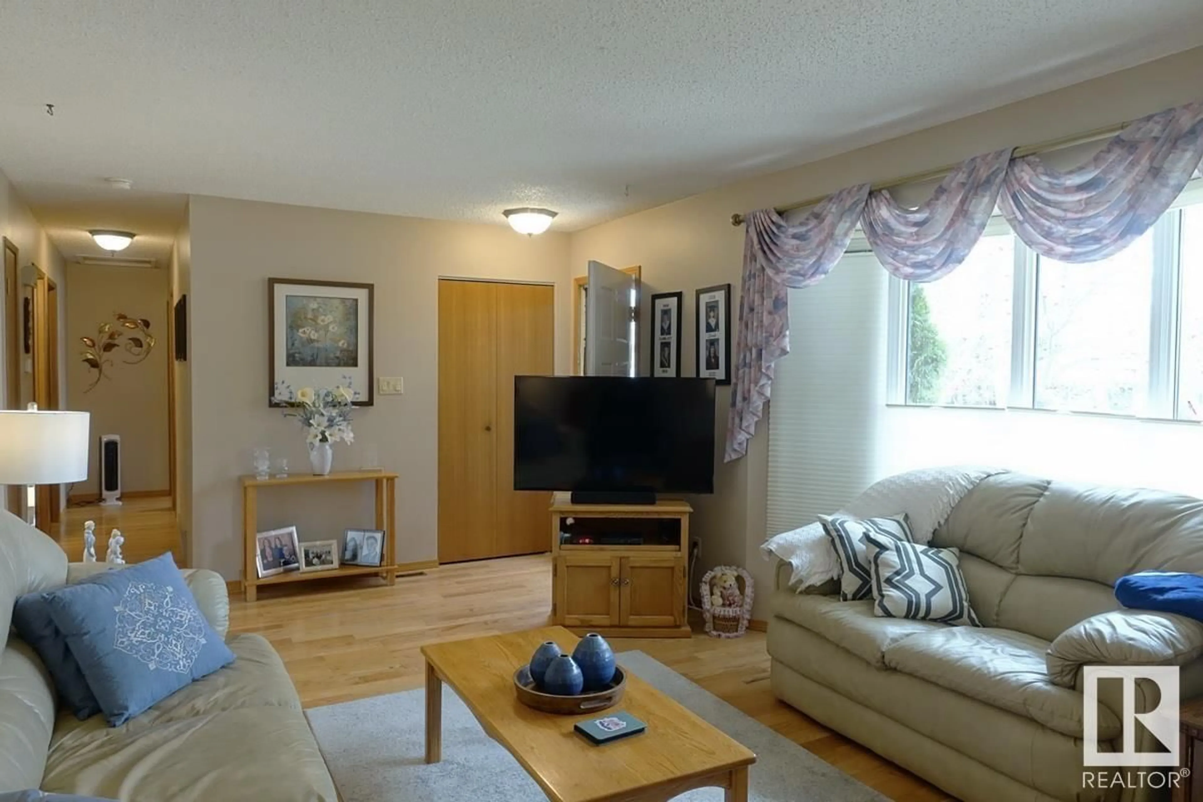 Living room with furniture, wood/laminate floor for 8217 99 AV, Fort Saskatchewan Alberta T8L3E4