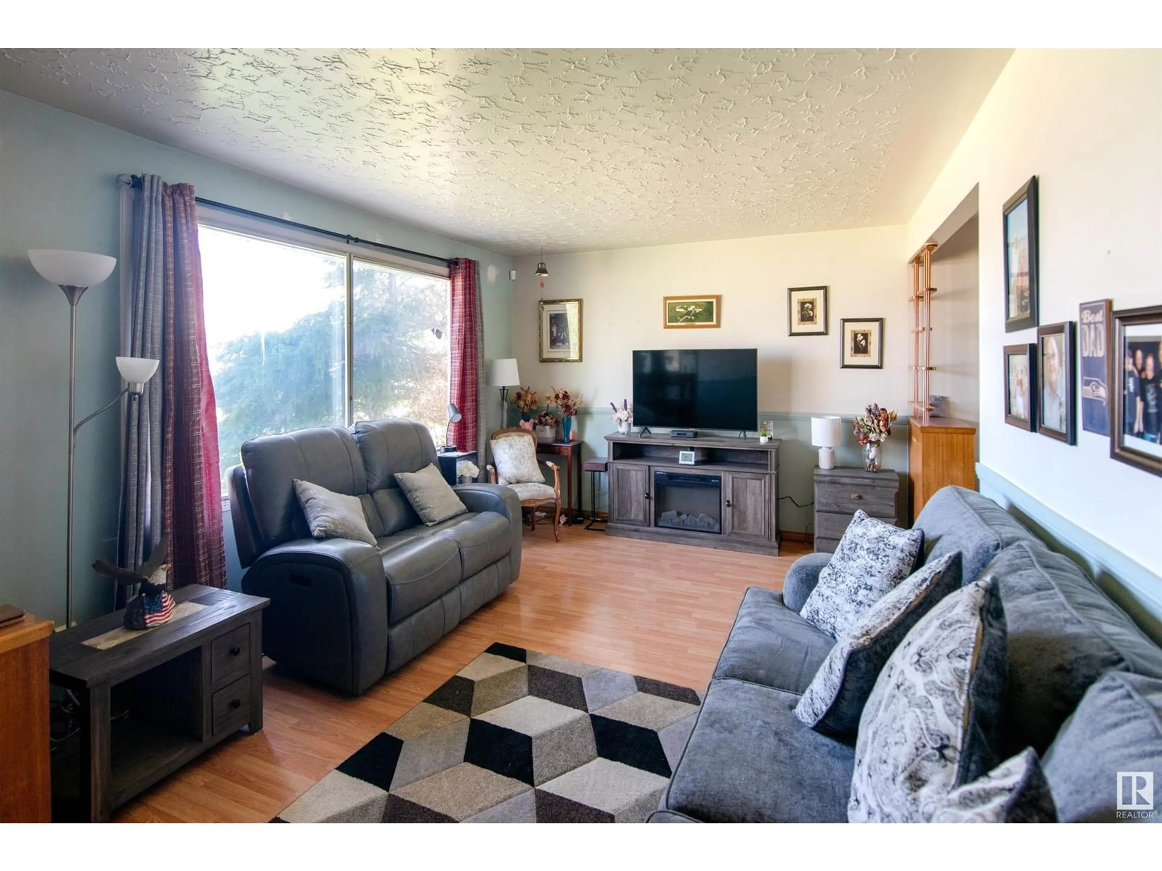 Living room with furniture, wood/laminate floor for 4724 46 AVE, Bonnyville Town Alberta T9N1N2