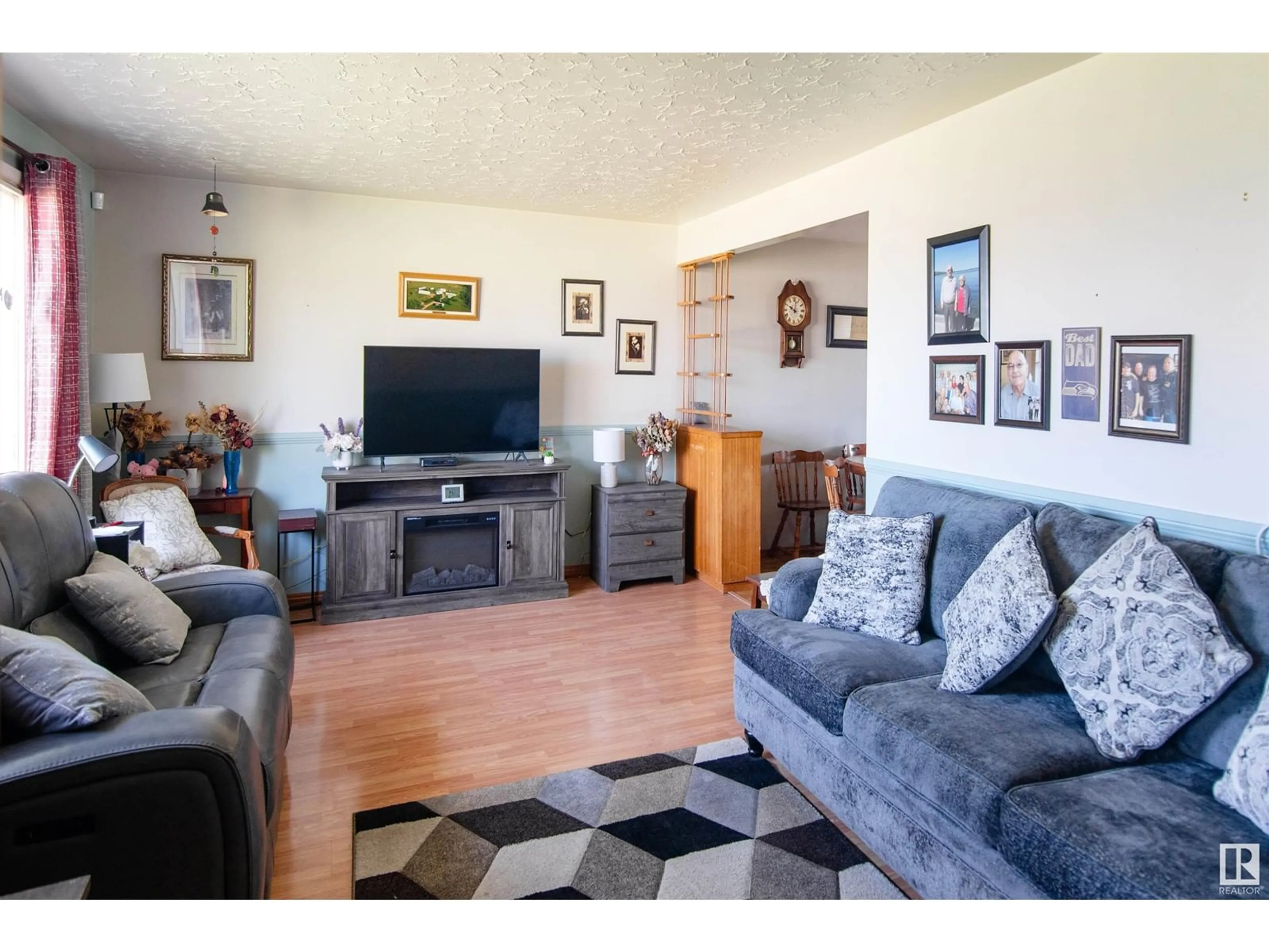 Living room with furniture, wood/laminate floor for 4724 46 AVE, Bonnyville Town Alberta T9N1N2