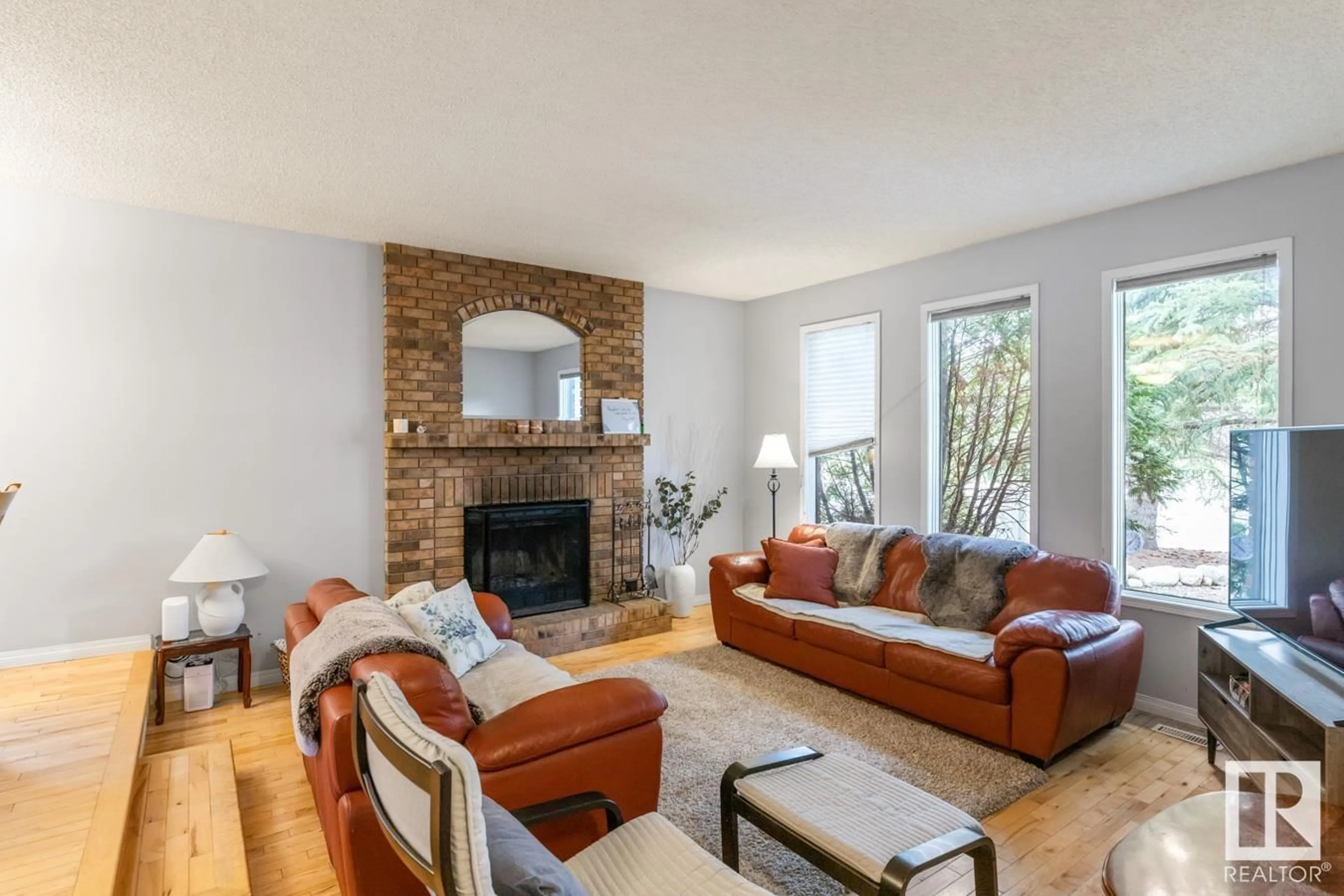Living room with furniture, wood/laminate floor for NW - 3450 37 ST, Edmonton Alberta T6L4Y9
