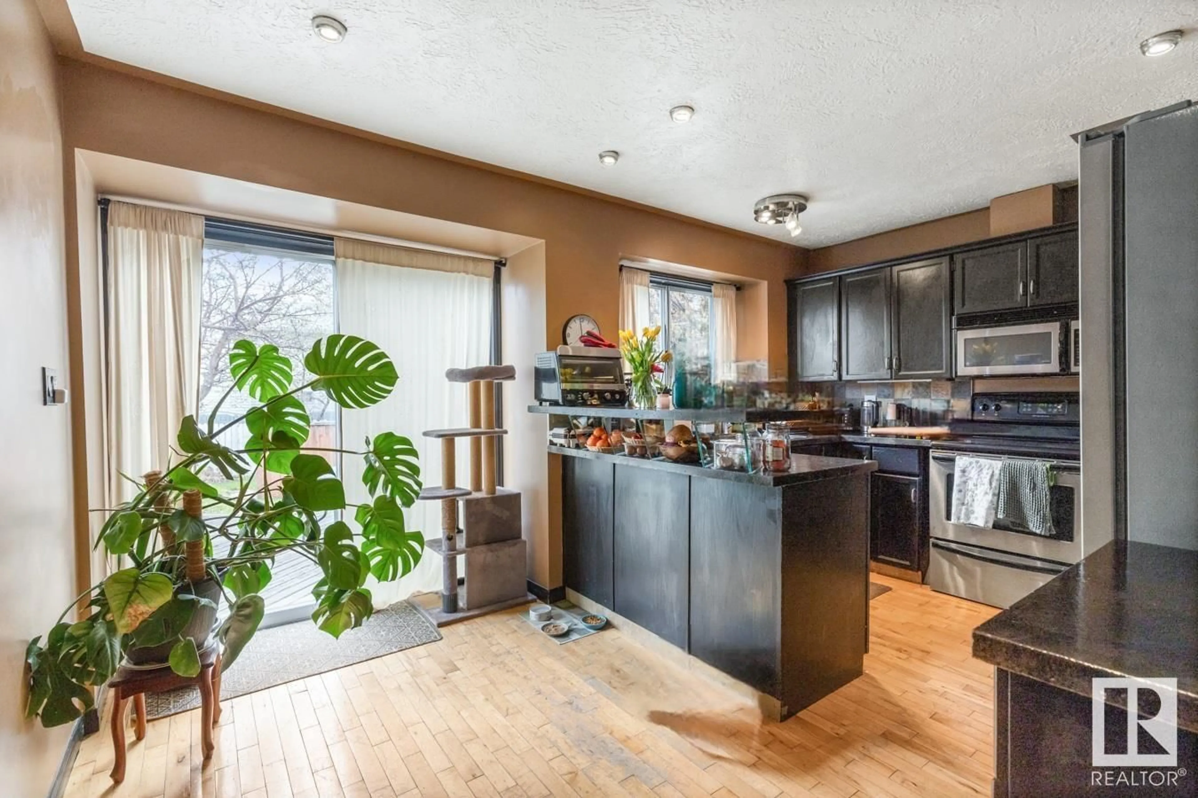 Open concept kitchen, wood/laminate floor for NW - 3450 37 ST, Edmonton Alberta T6L4Y9