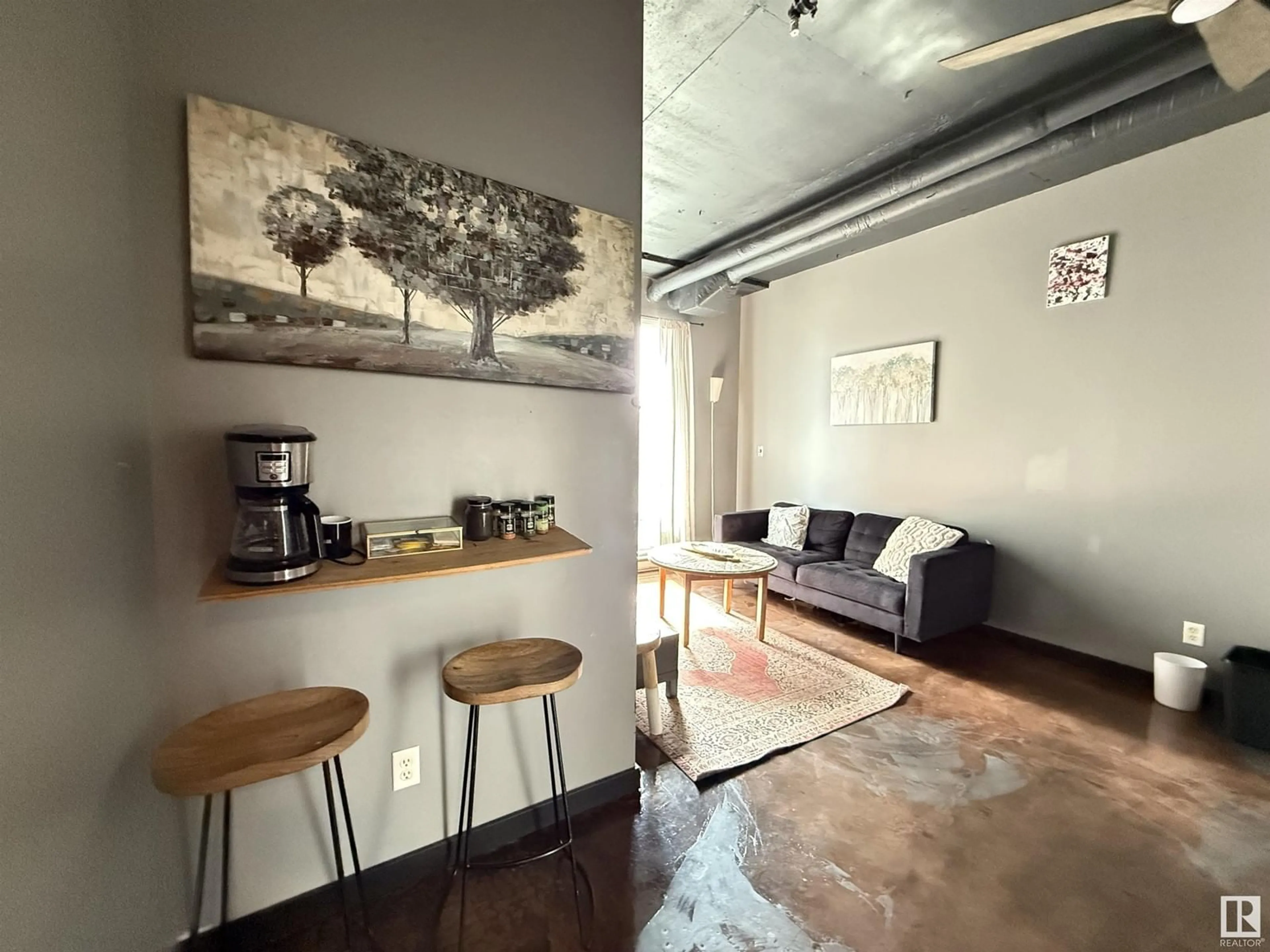 Living room with furniture, cement floor for 10024 - 612 JASPER AV, Edmonton Alberta T5J1R9