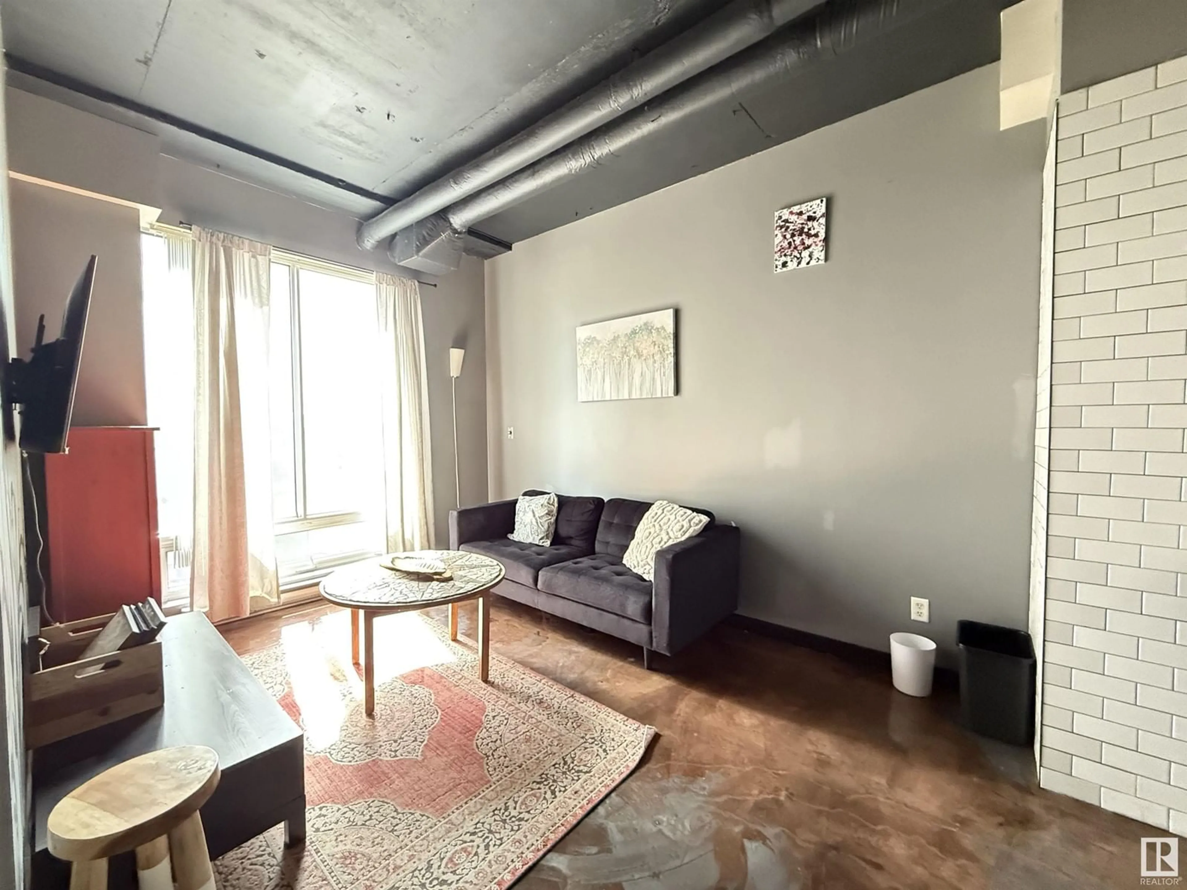 Living room with furniture, cement floor for 10024 - 612 JASPER AV, Edmonton Alberta T5J1R9