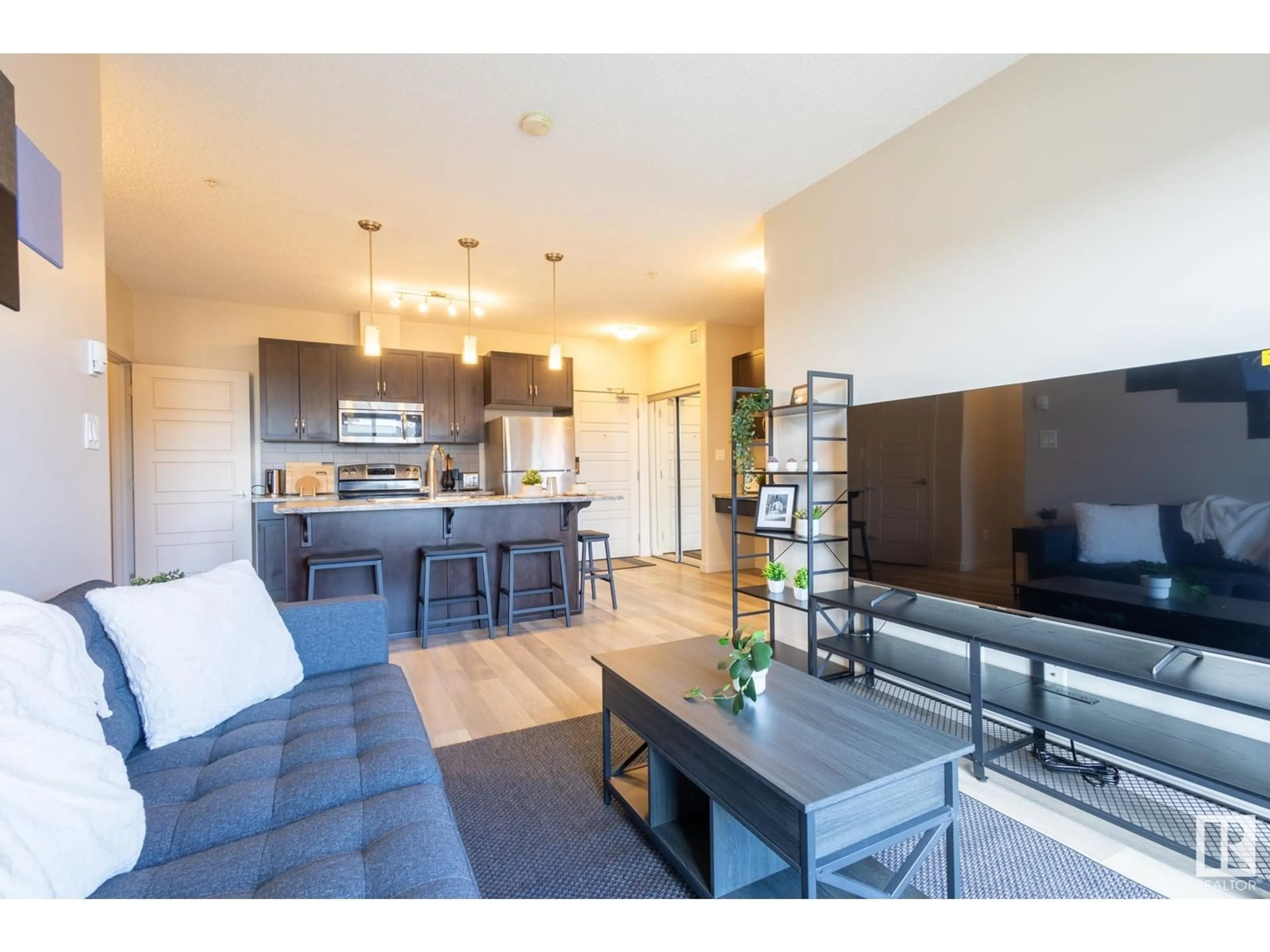 Open concept kitchen, wood/laminate floor for 403 - 320 AMBLESIDE LINK, Edmonton Alberta T6W2Z9