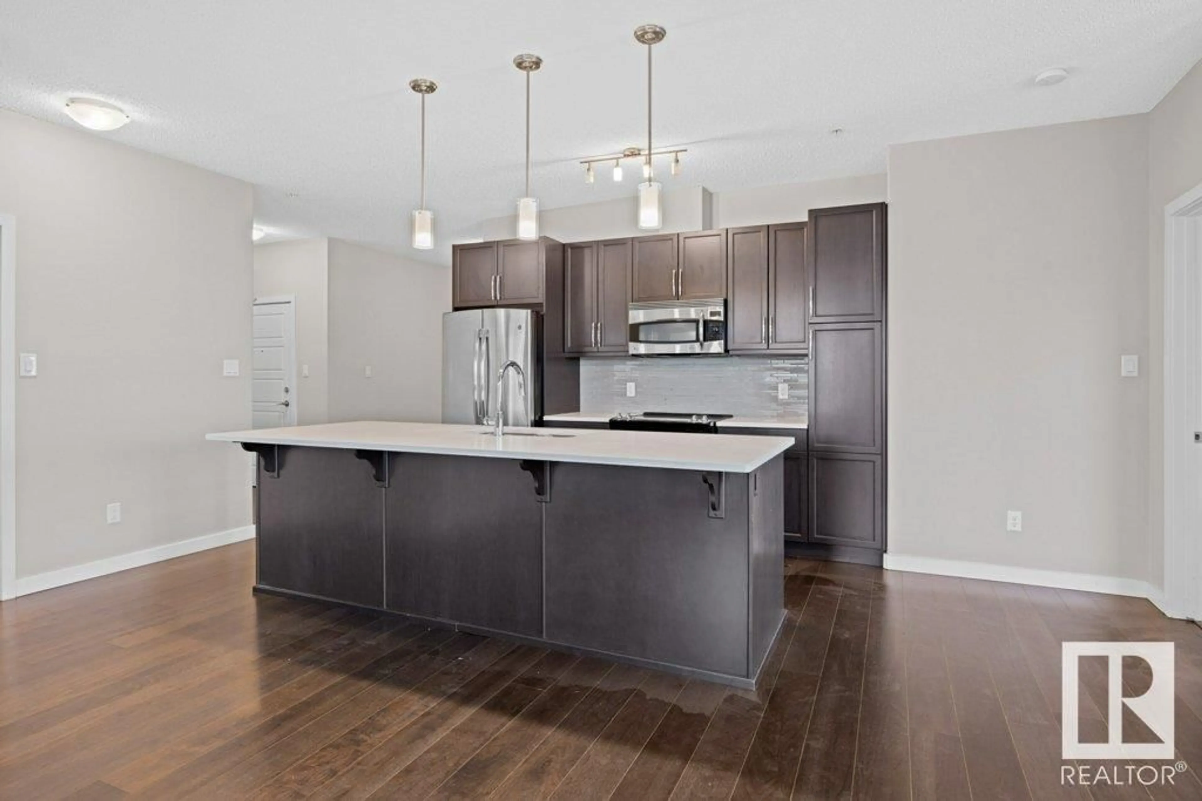 Open concept kitchen, wood/laminate floor for 320 - 122 AMBLESIDE LINK LI, Edmonton Alberta T6W2Z9