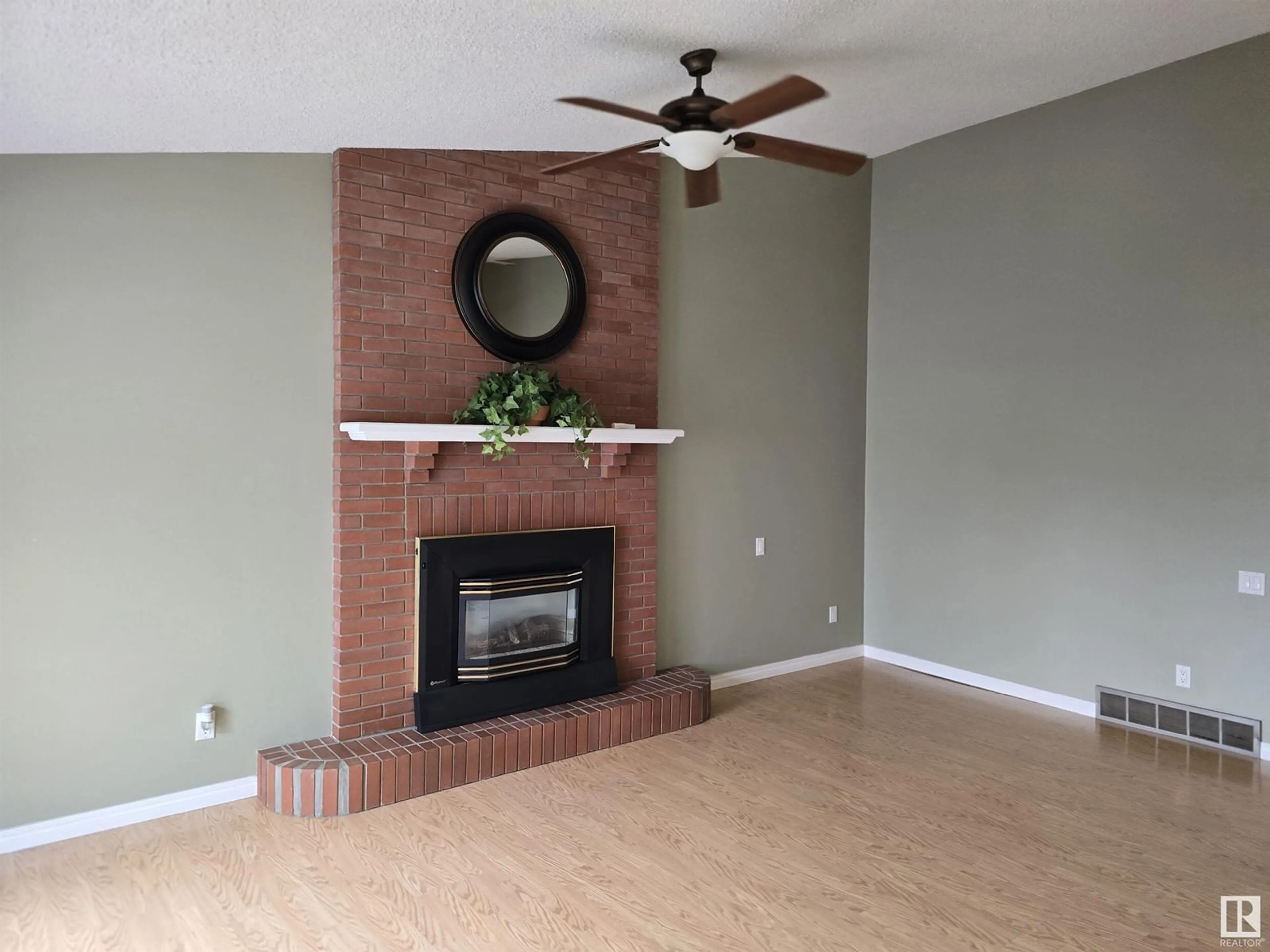 Living room with furniture, wood/laminate floor for 18916 78 AV, Edmonton Alberta T5T5J2