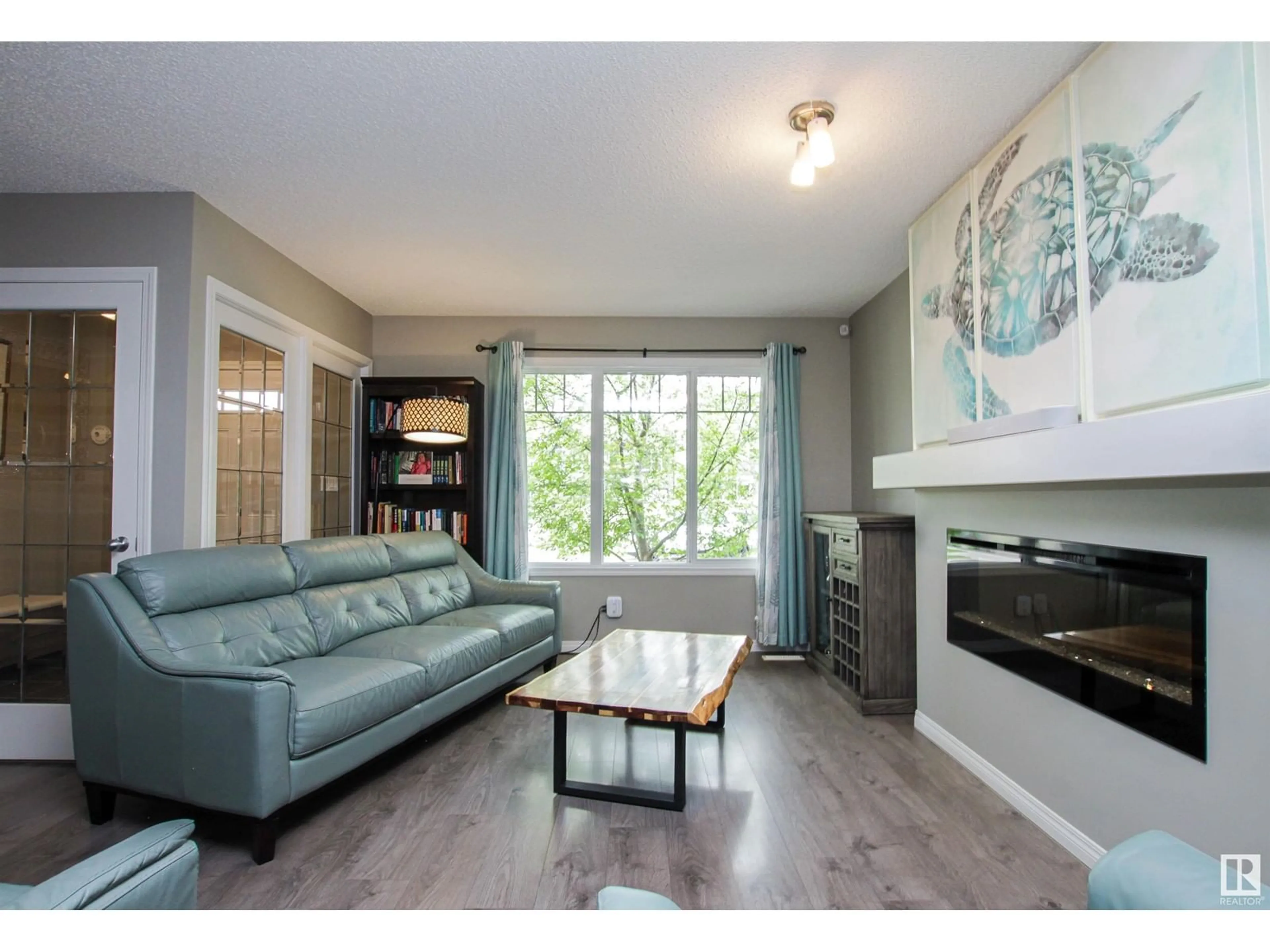 Living room with furniture, wood/laminate floor for SW - 3347 ORCHARDS LINK LI, Edmonton Alberta T6X2B4