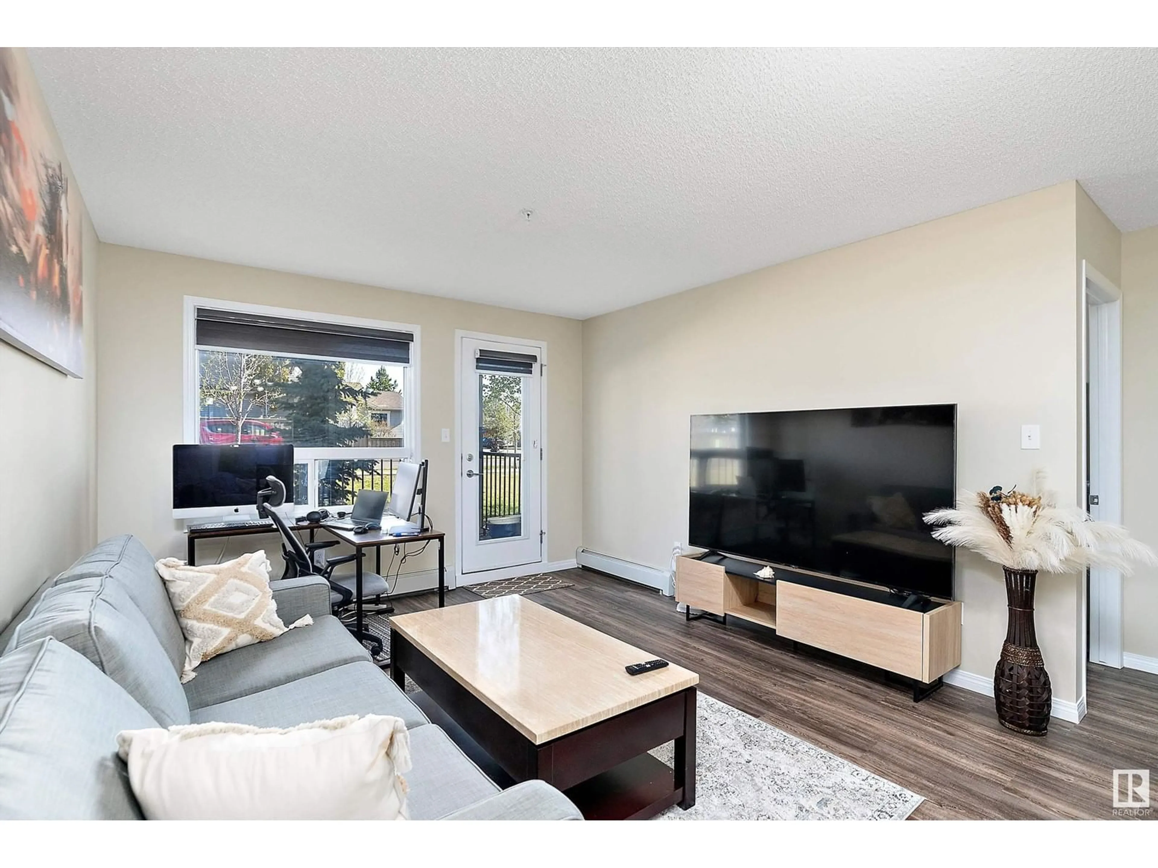 Living room with furniture, wood/laminate floor for 9351 - 3115 SIMPSON DR, Edmonton Alberta T6R0N4