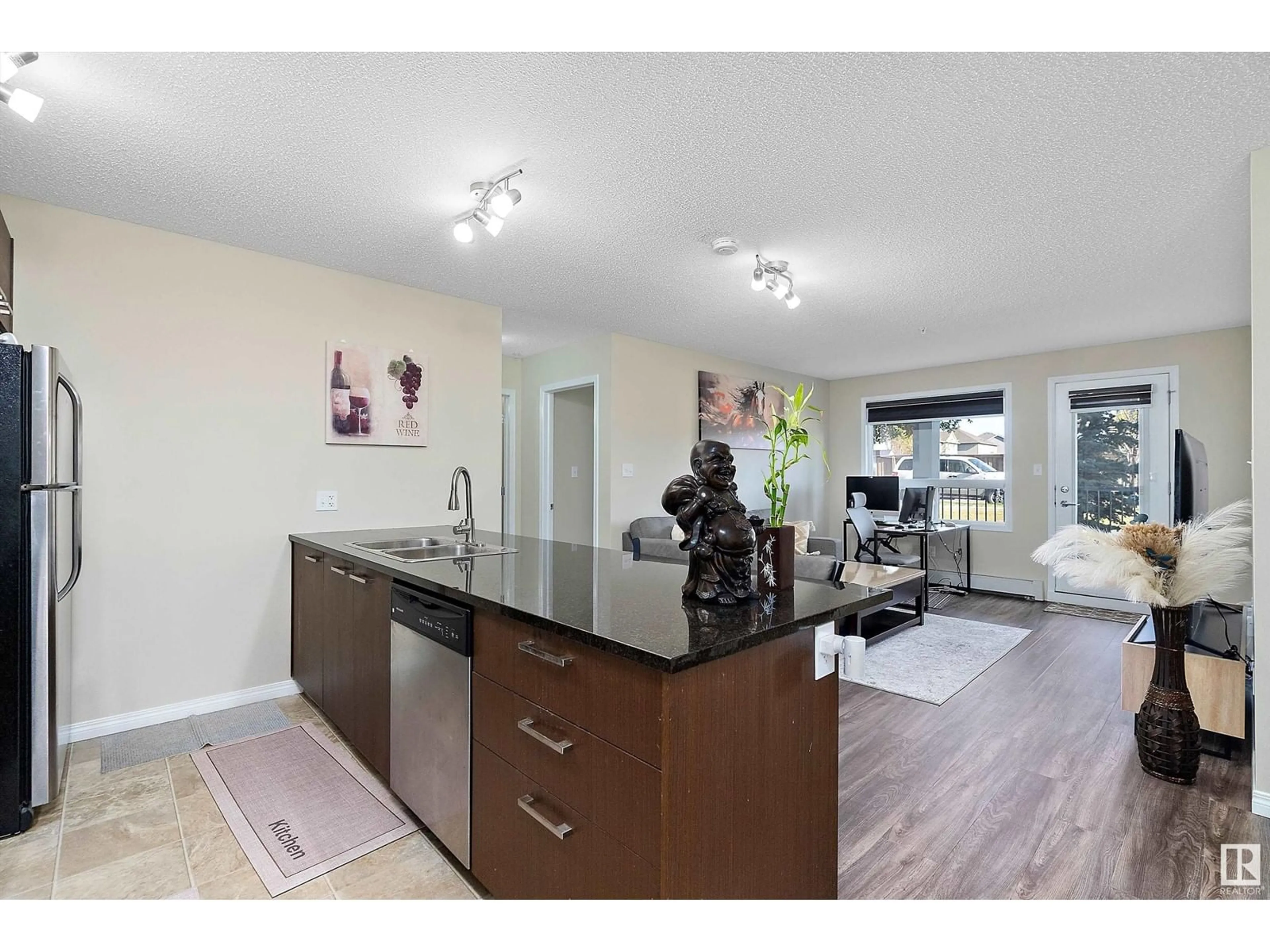 Open concept kitchen, wood/laminate floor for 9351 - 3115 SIMPSON DR, Edmonton Alberta T6R0N4
