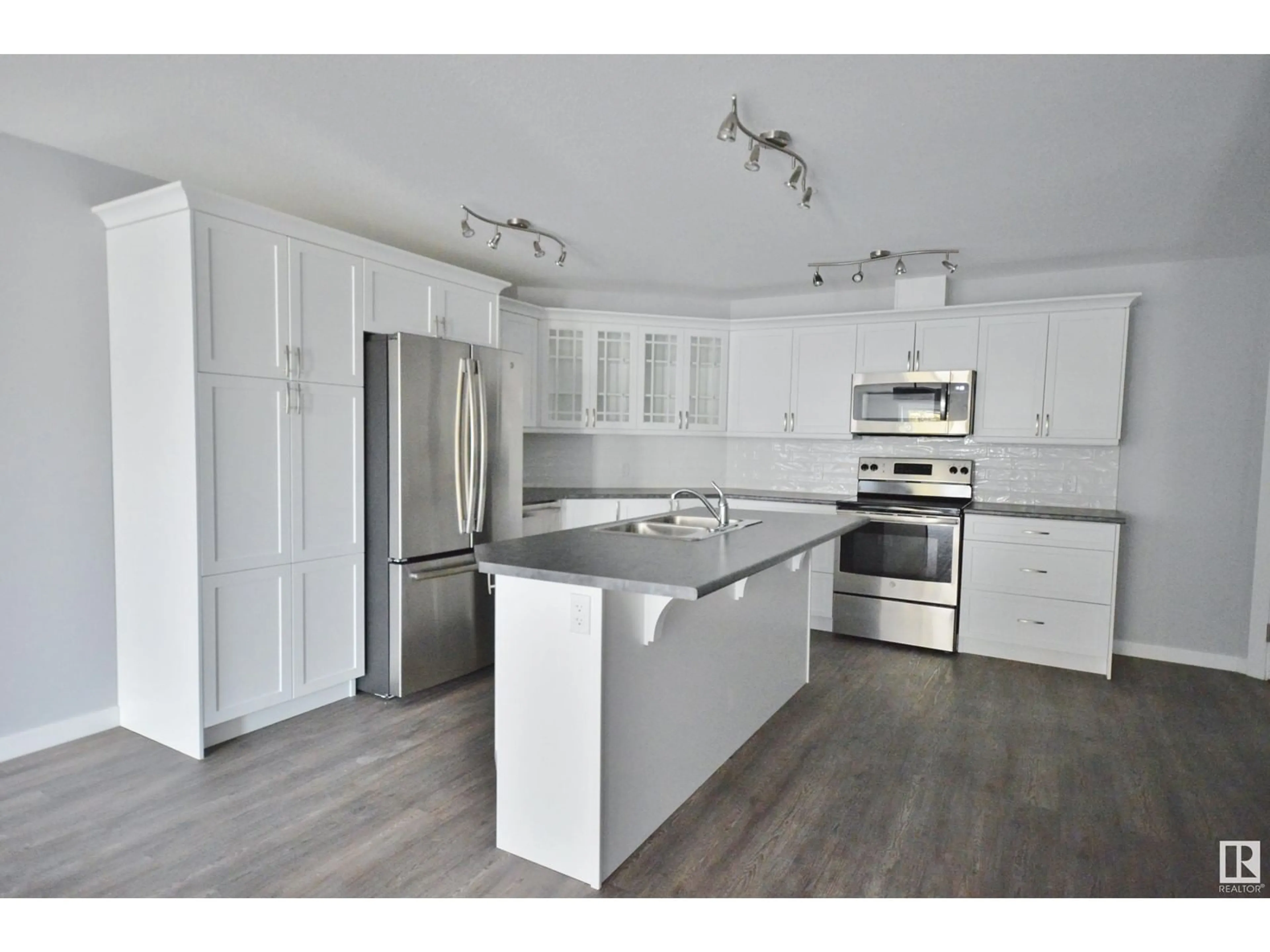 Open concept kitchen, wood/laminate floor for 202 - 4110 43 AV, Bonnyville Town Alberta T9N1S8