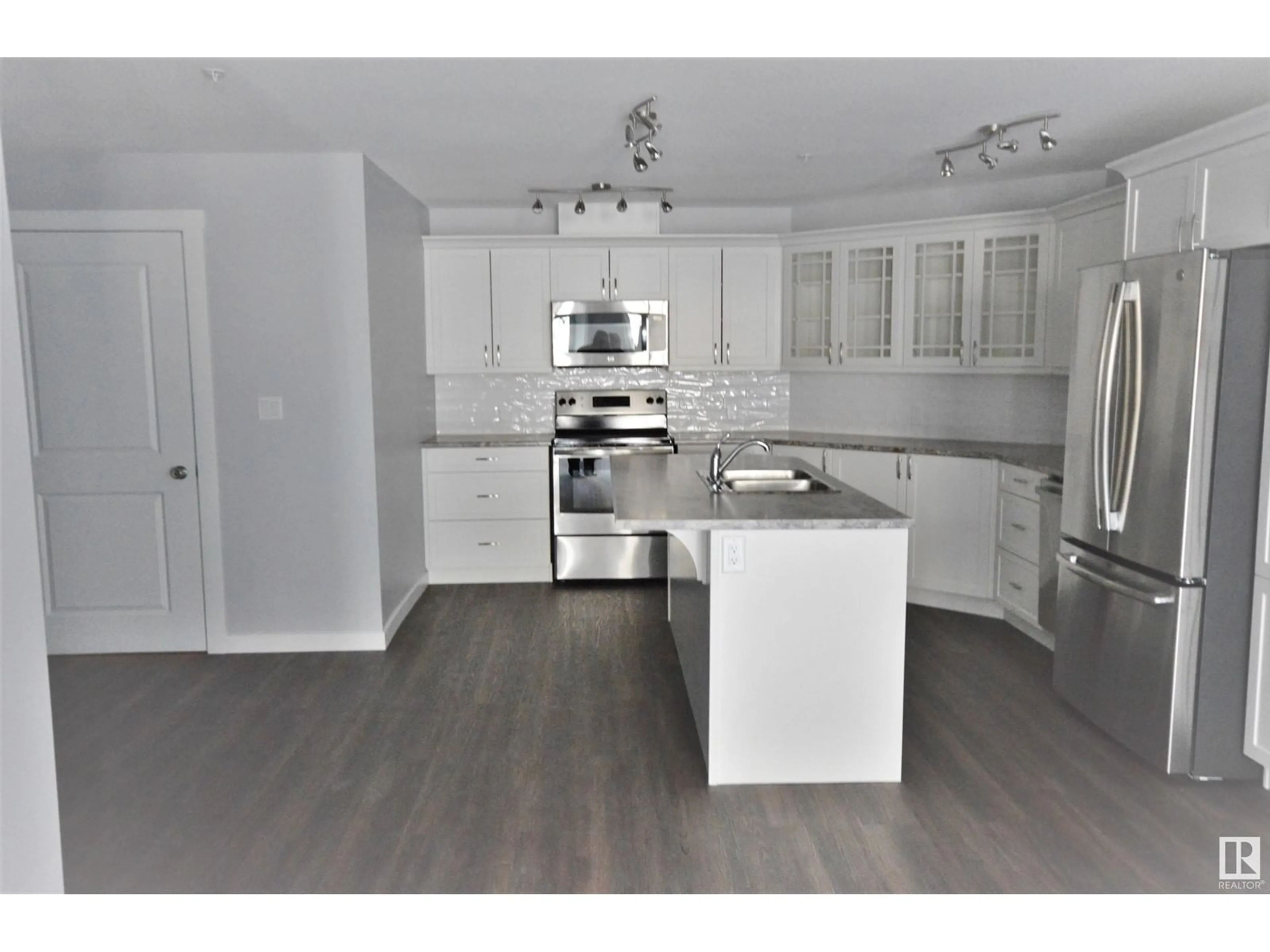 Open concept kitchen, wood/laminate floor for 105 - 4110 43 AV, Bonnyville Town Alberta T9N1S8