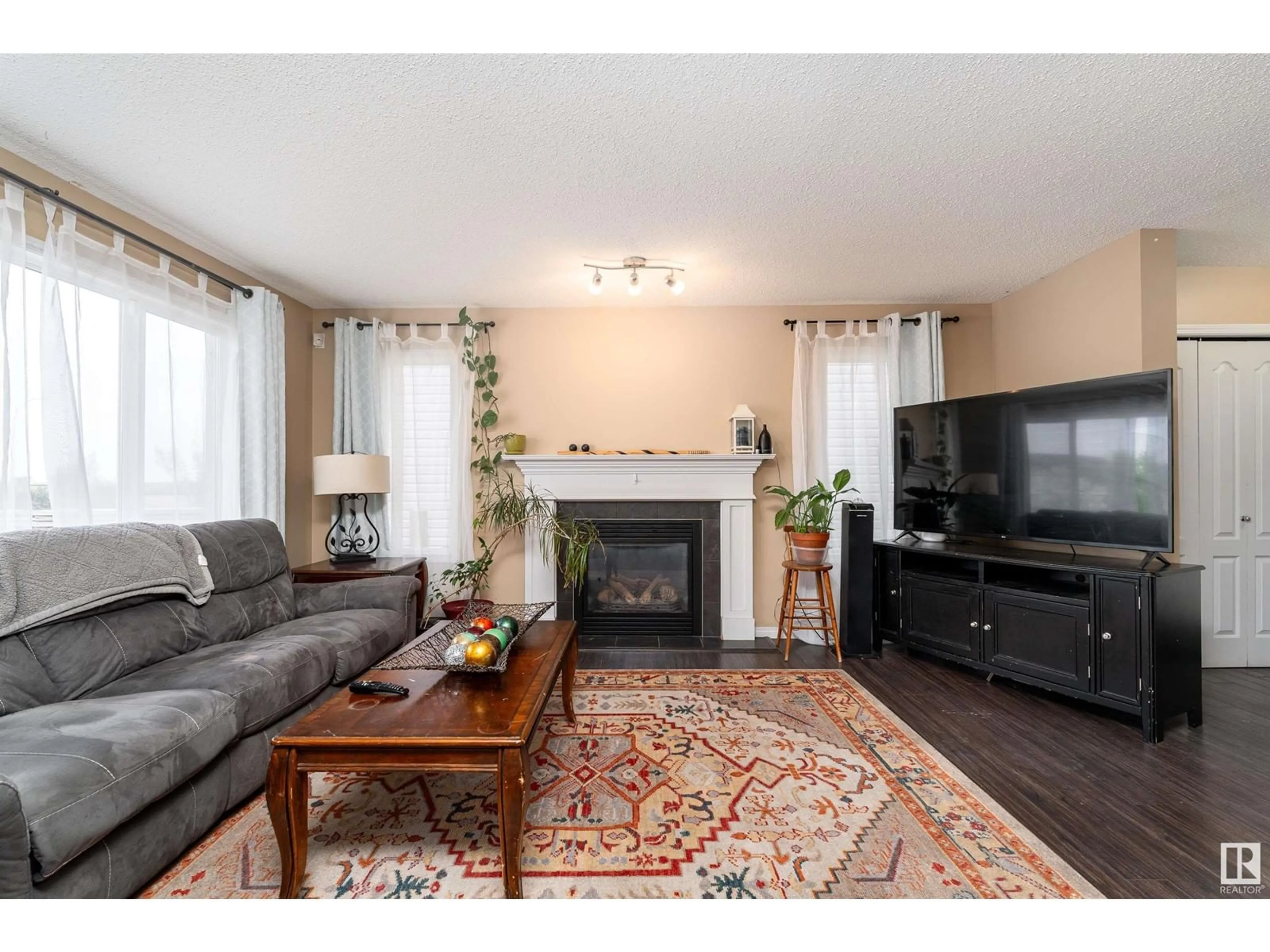 Living room with furniture, wood/laminate floor for 3636 166 AV, Edmonton Alberta T5Y0N8