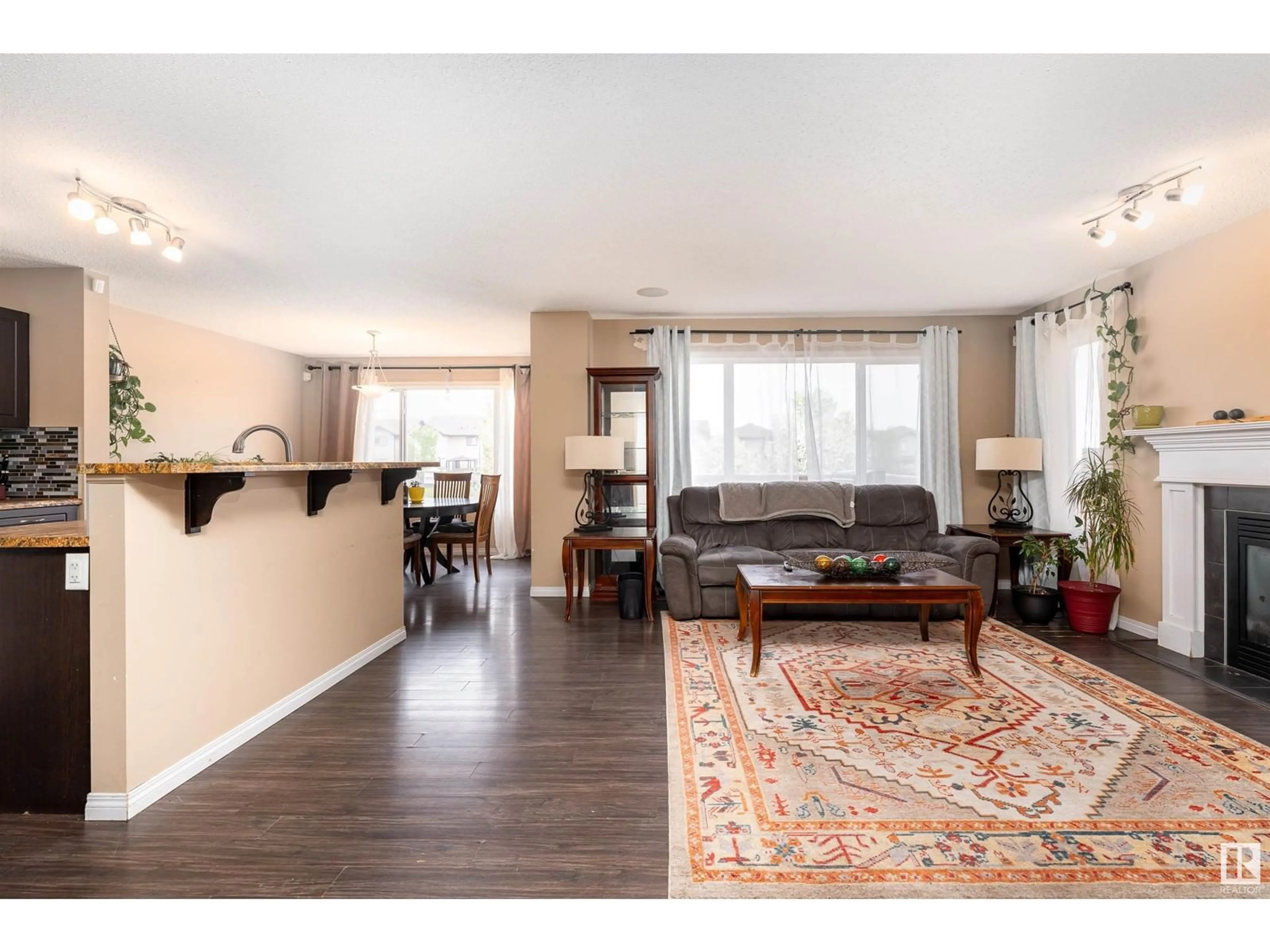 Living room with furniture, wood/laminate floor for 3636 166 AV, Edmonton Alberta T5Y0N8