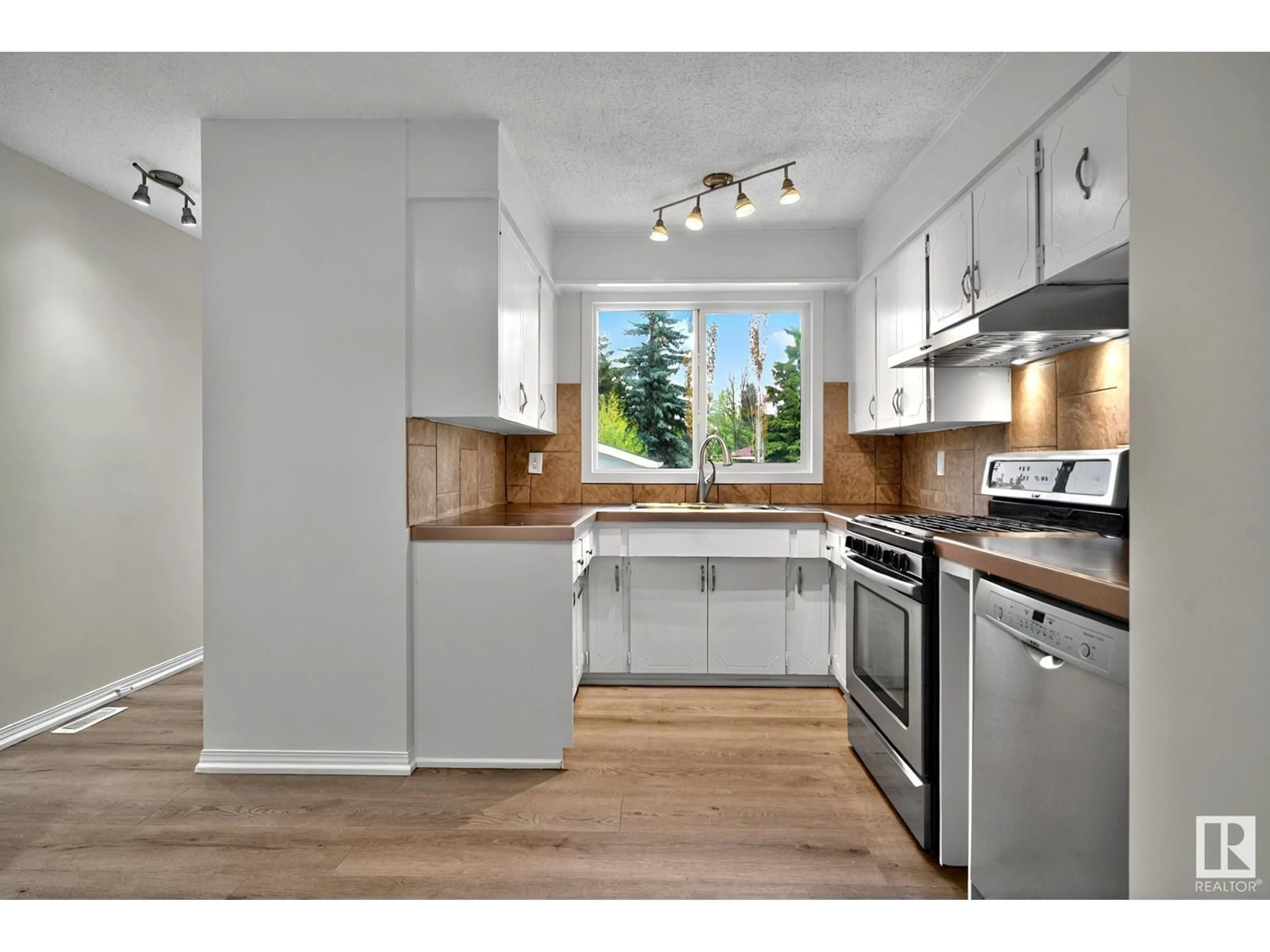 Open concept kitchen, wood/laminate floor for 4312 43 AV, Leduc Alberta T9E4R7
