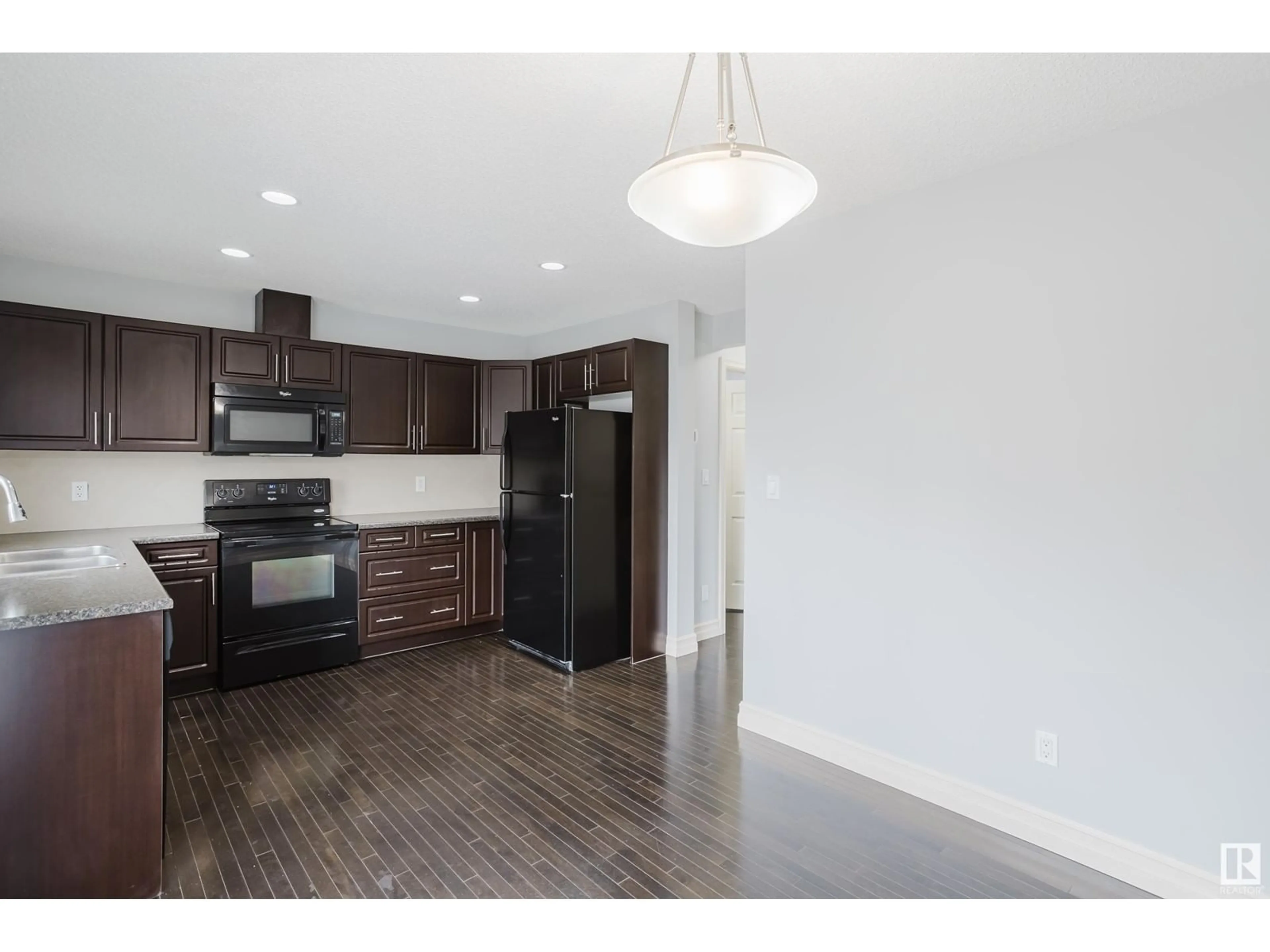Open concept kitchen, wood/laminate floor for #107 - 219 CHARLOTTE WY, Sherwood Park Alberta T8H0T3