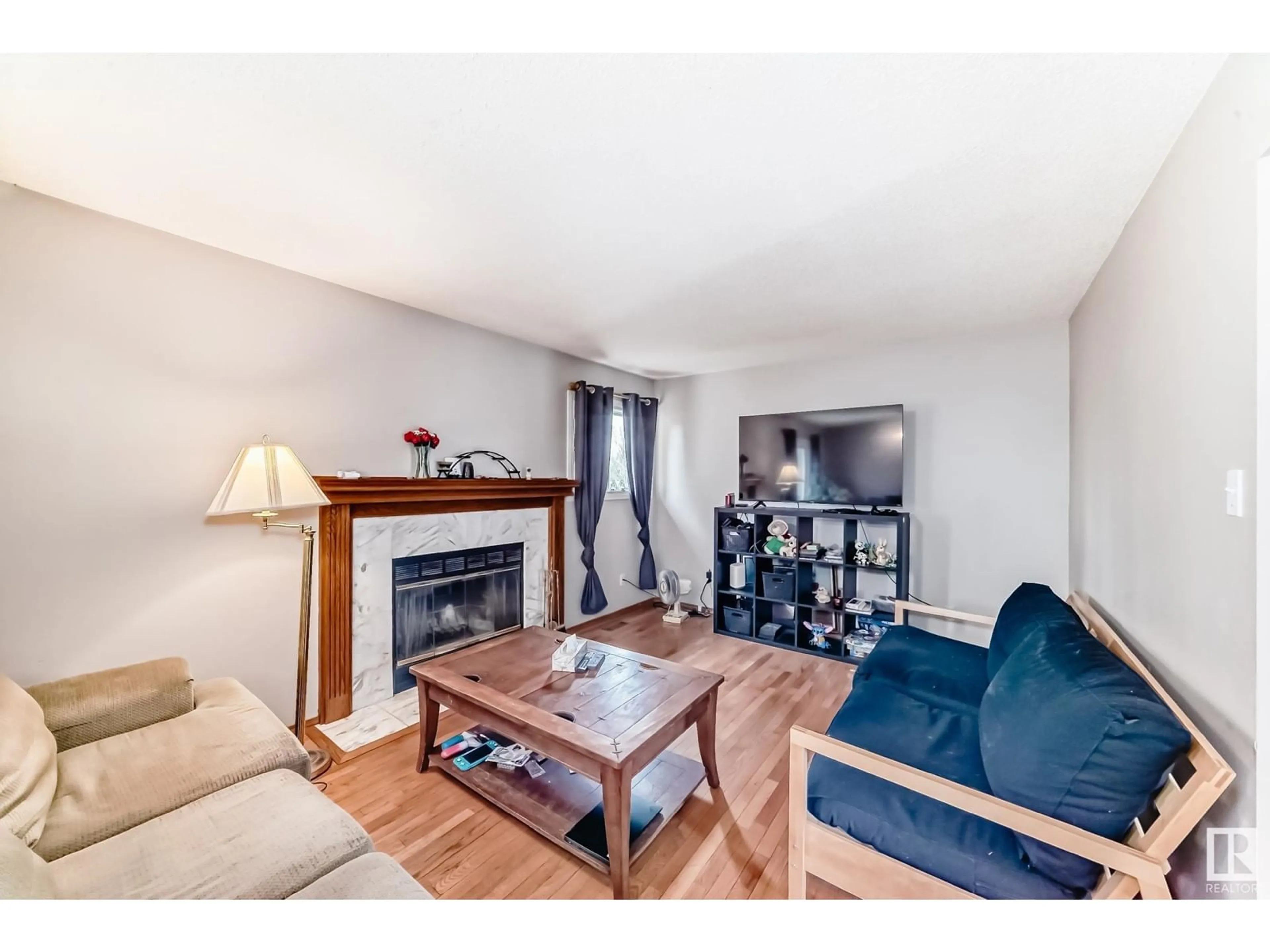Living room with furniture, wood/laminate floor for 6946 31 AV, Edmonton Alberta T6K3X6