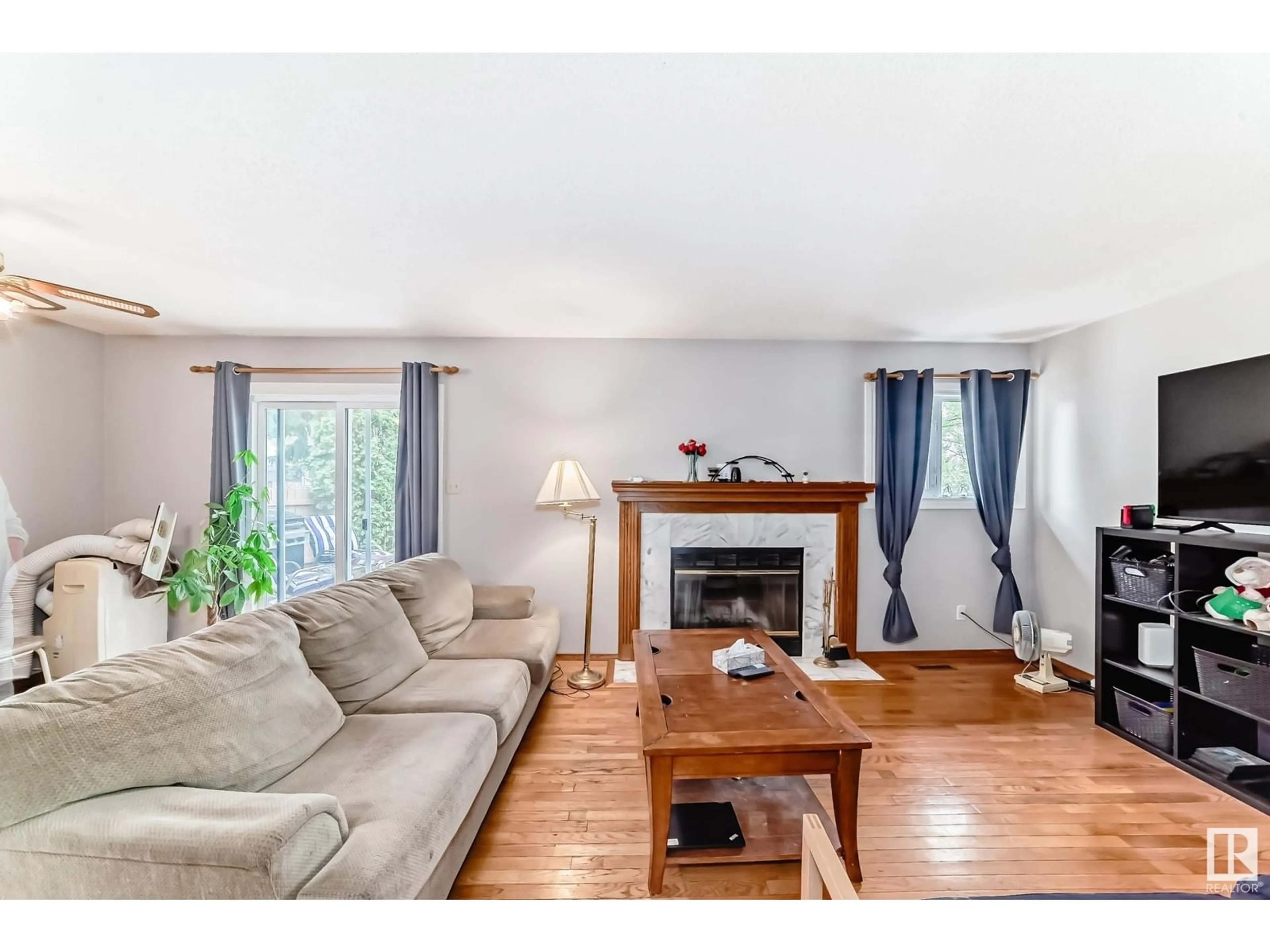 Living room with furniture, wood/laminate floor for 6946 31 AV, Edmonton Alberta T6K3X6