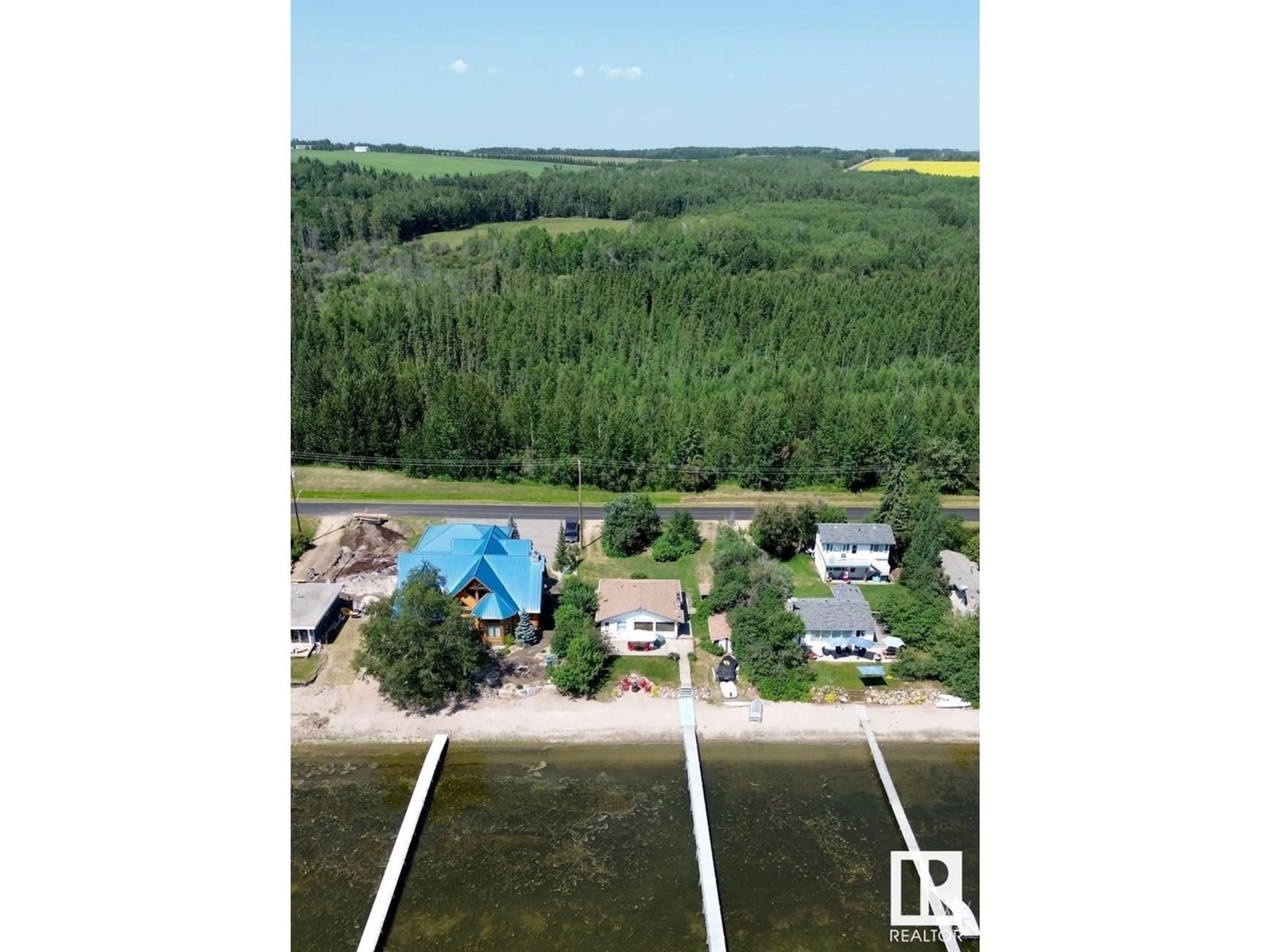 A pic from outside/outdoor area/front of a property/back of a property/a pic from drone, water/lake/river/ocean view for 61 ARGENTIA BE, Rural Wetaskiwin County Alberta T0C2C0