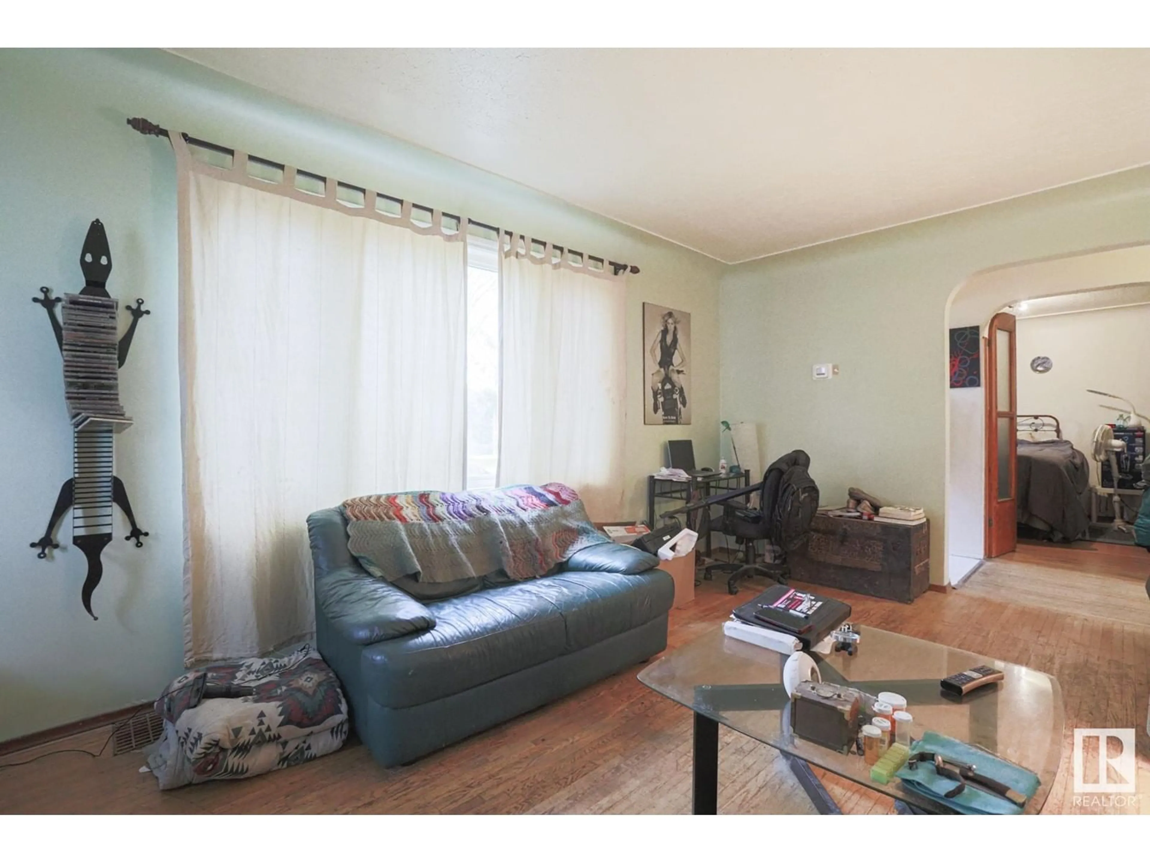Living room with furniture, wood/laminate floor for 11207 71 AV, Edmonton Alberta T6G0A1