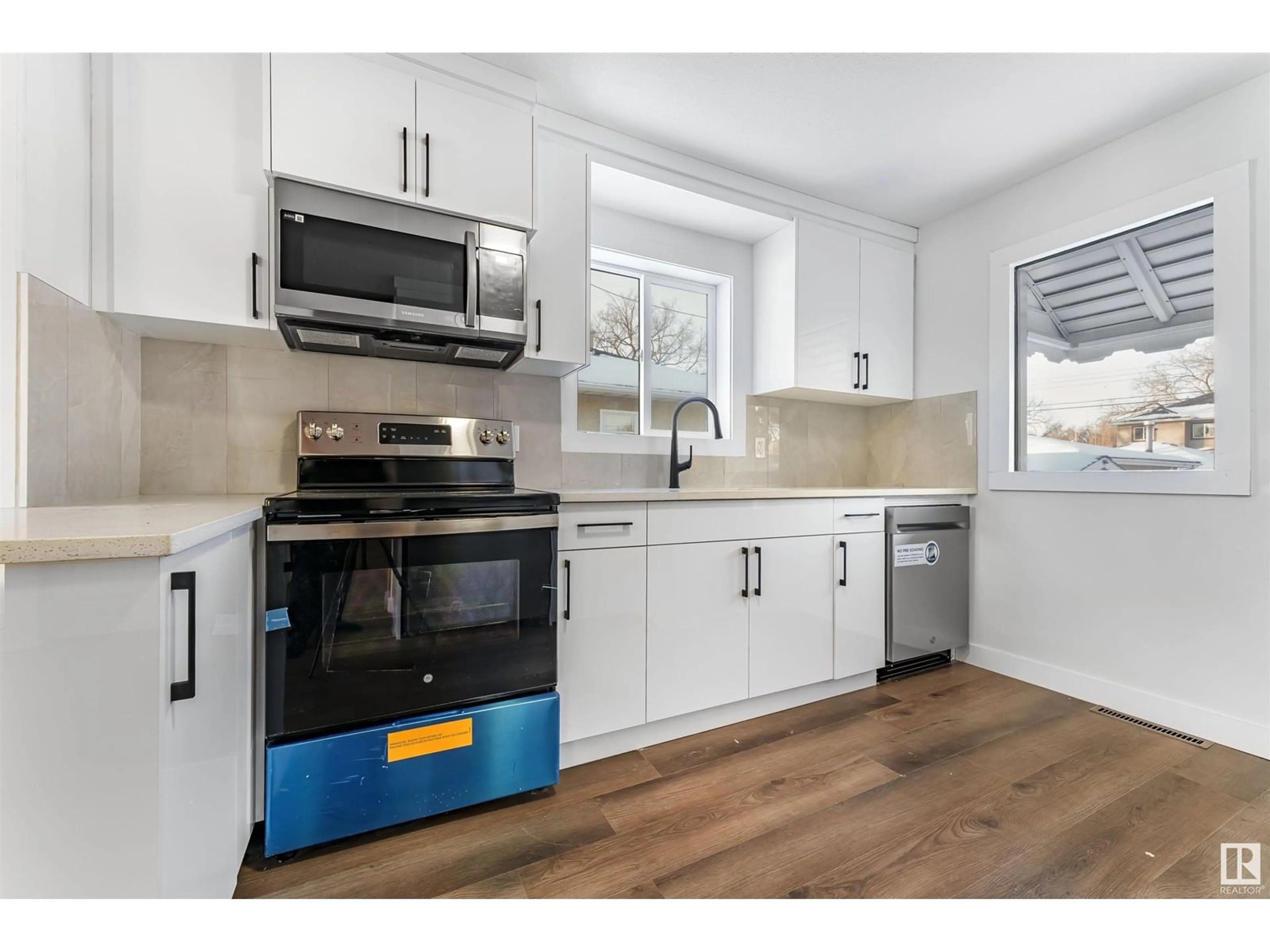 Open concept kitchen, wood/laminate floor for NW - 11906 50 ST, Edmonton Alberta T5W3C2