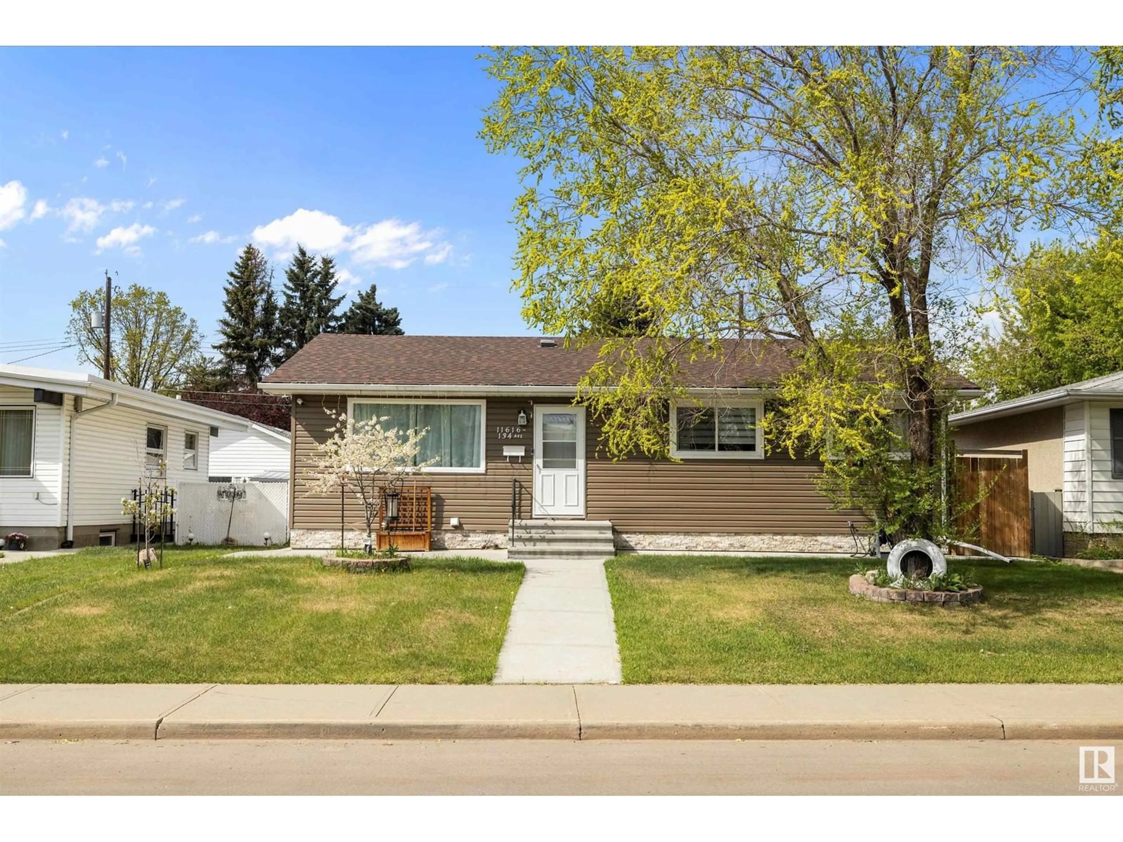 Home with vinyl exterior material, street for 11616 134 AV, Edmonton Alberta T5E1K9