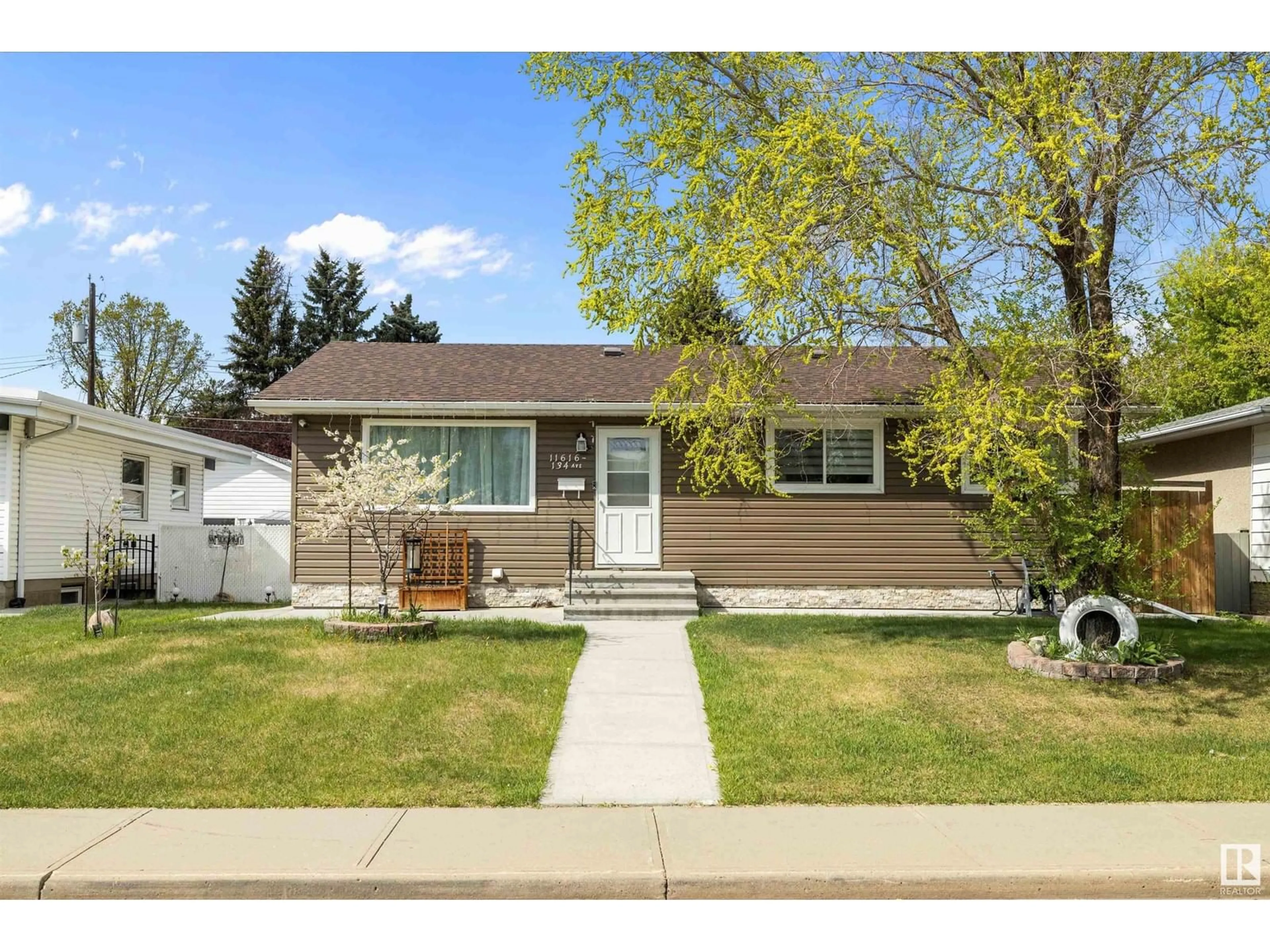 Home with vinyl exterior material, street for 11616 134 AV, Edmonton Alberta T5E1K9