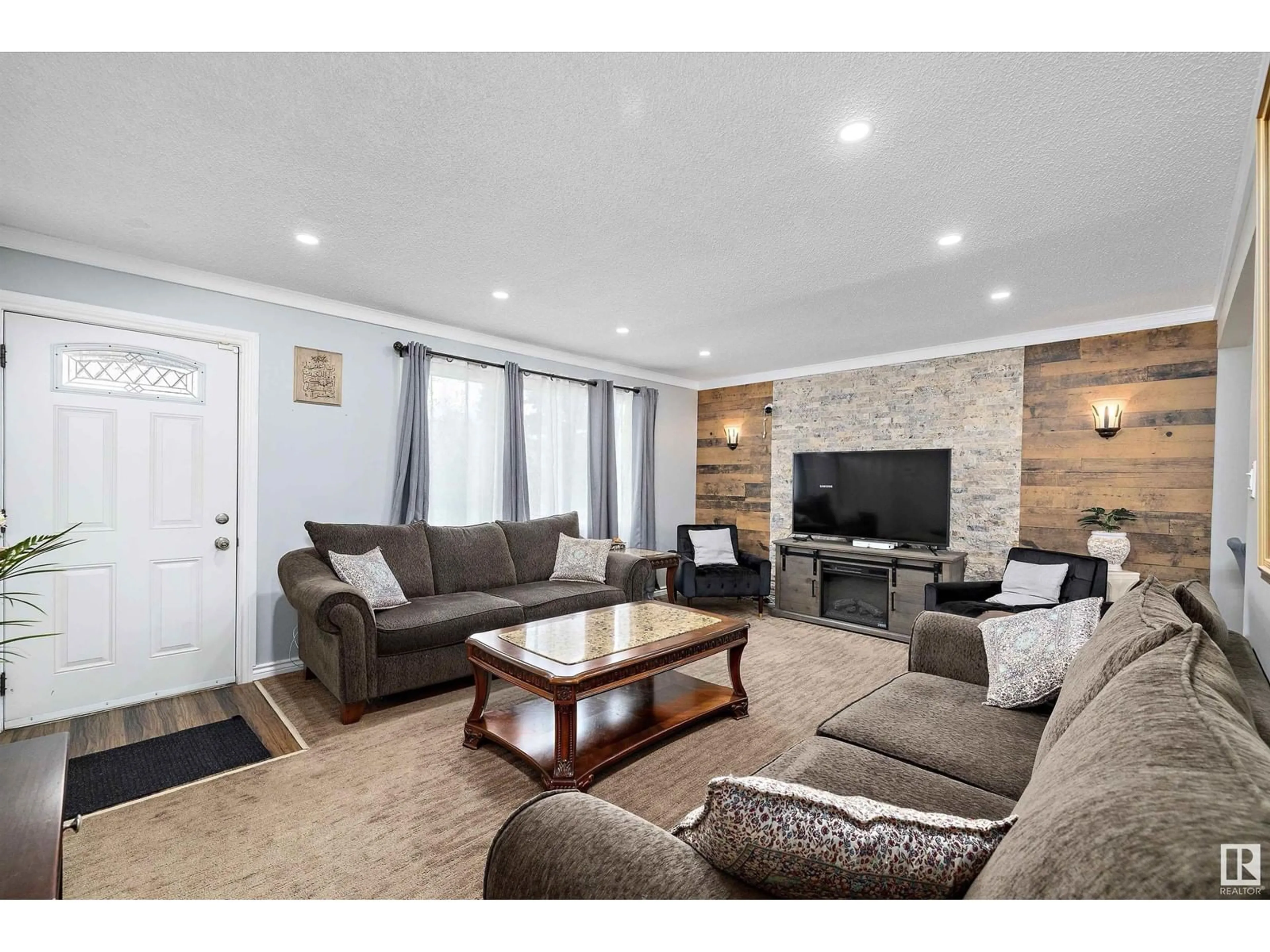 Living room with furniture, wood/laminate floor for 11616 134 AV, Edmonton Alberta T5E1K9