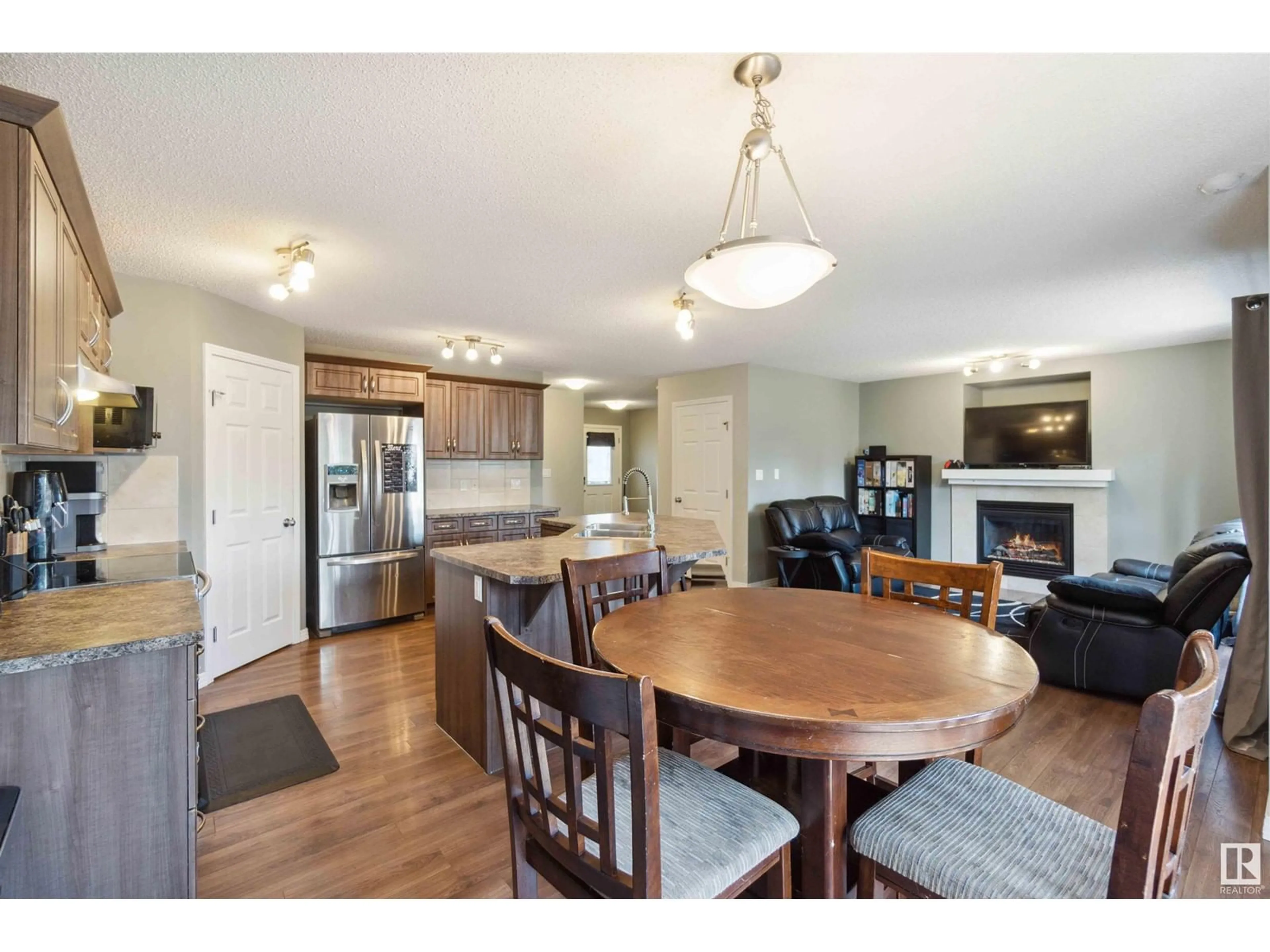 Open concept kitchen, wood/laminate floor for 219 AVENA CI, Leduc Alberta T9E0L8