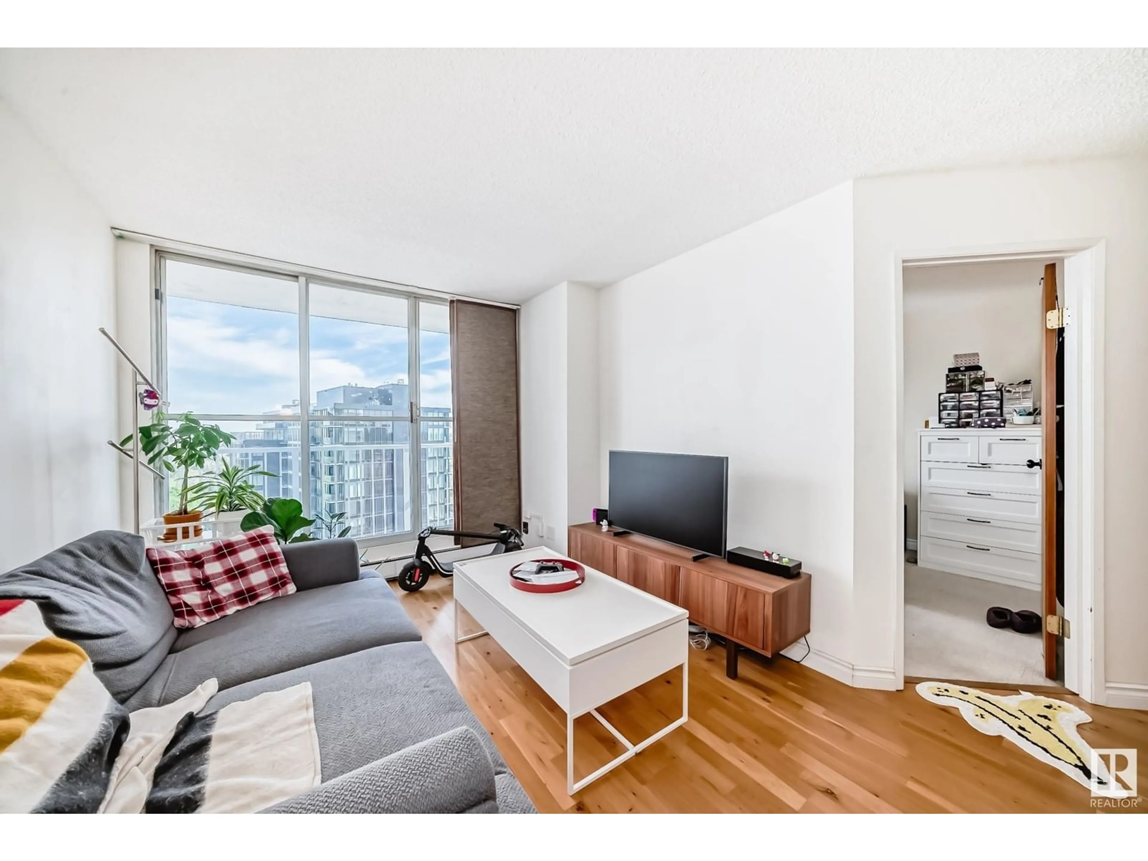 Living room with furniture, wood/laminate floor for 12141 - 1203 JASPER AV, Edmonton Alberta T5N3X8