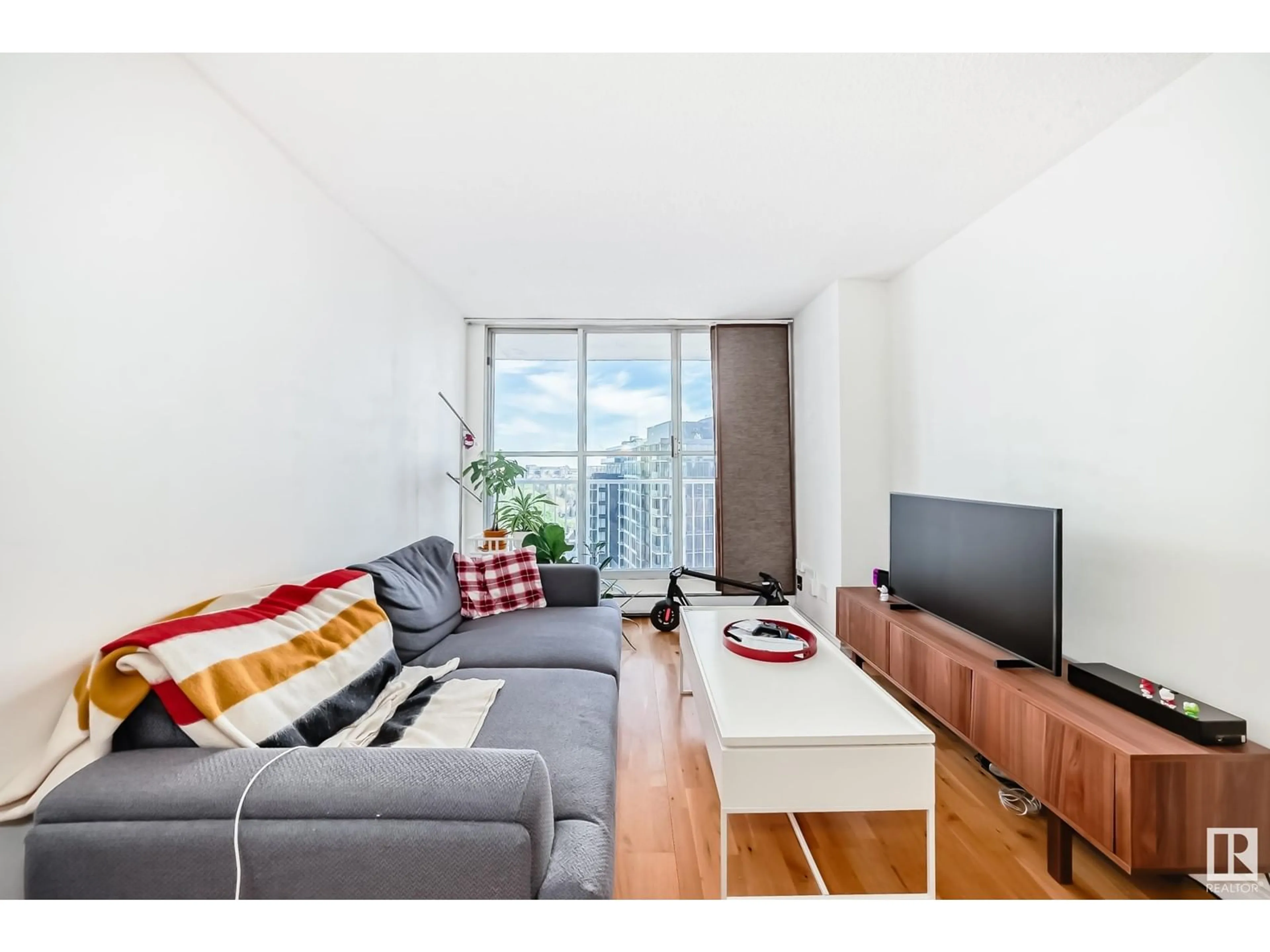 Living room with furniture, wood/laminate floor for 12141 - 1203 JASPER AV, Edmonton Alberta T5N3X8