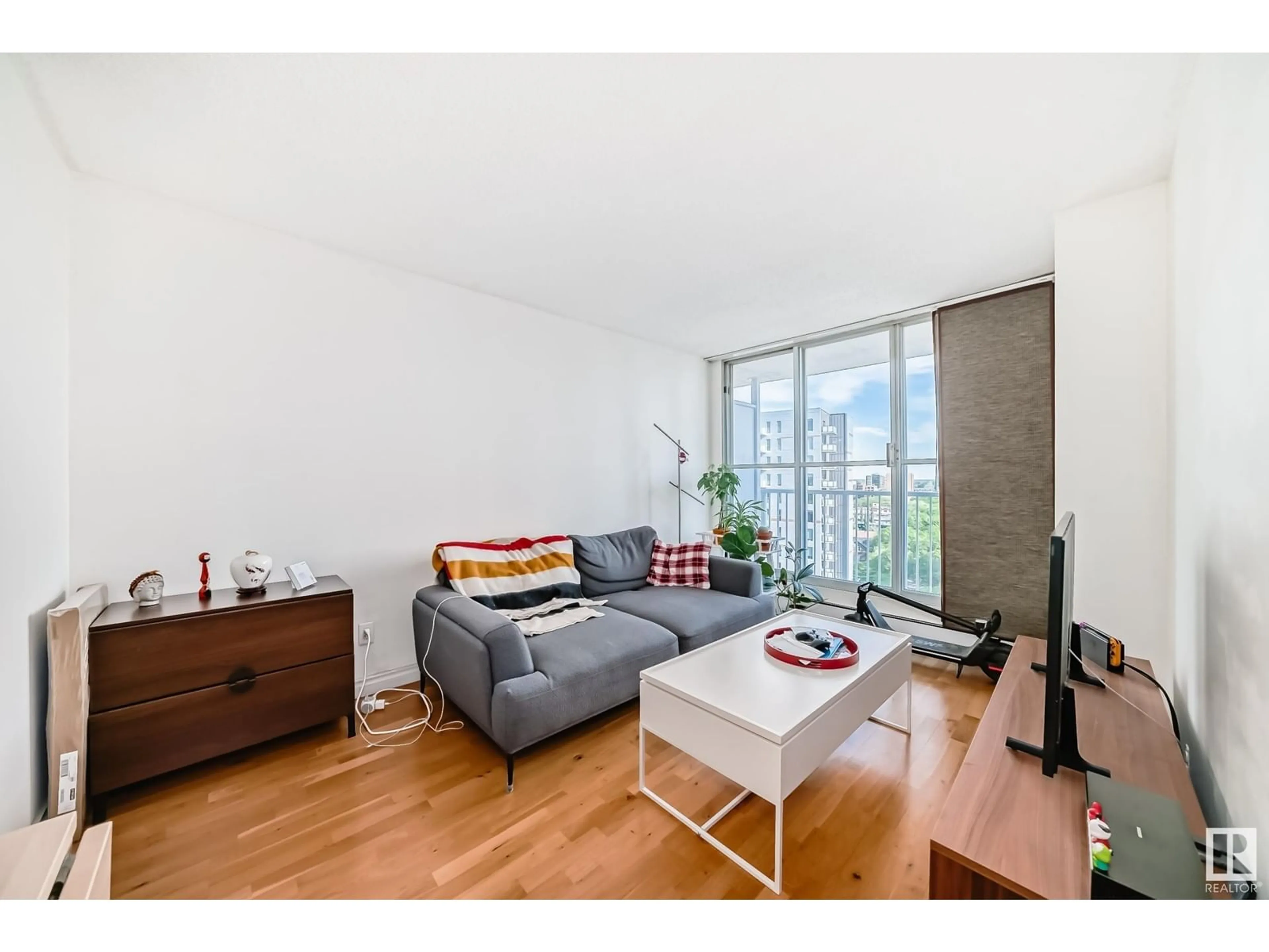 Living room with furniture, wood/laminate floor for 12141 - 1203 JASPER AV, Edmonton Alberta T5N3X8